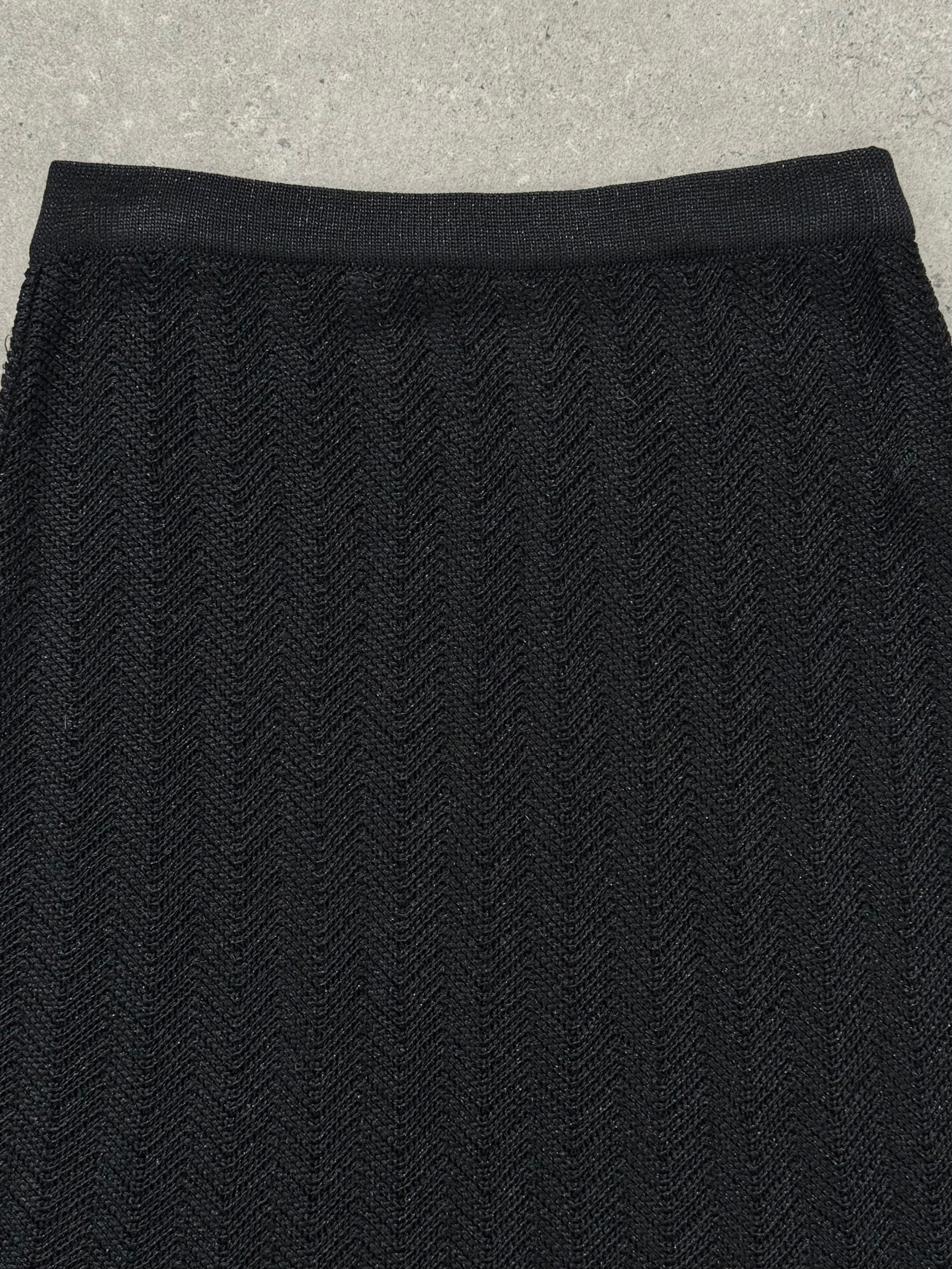 Vintage 1990s knit mini skirt in neutral tones, showing a close-up of the textured fabric and high-waisted fit.