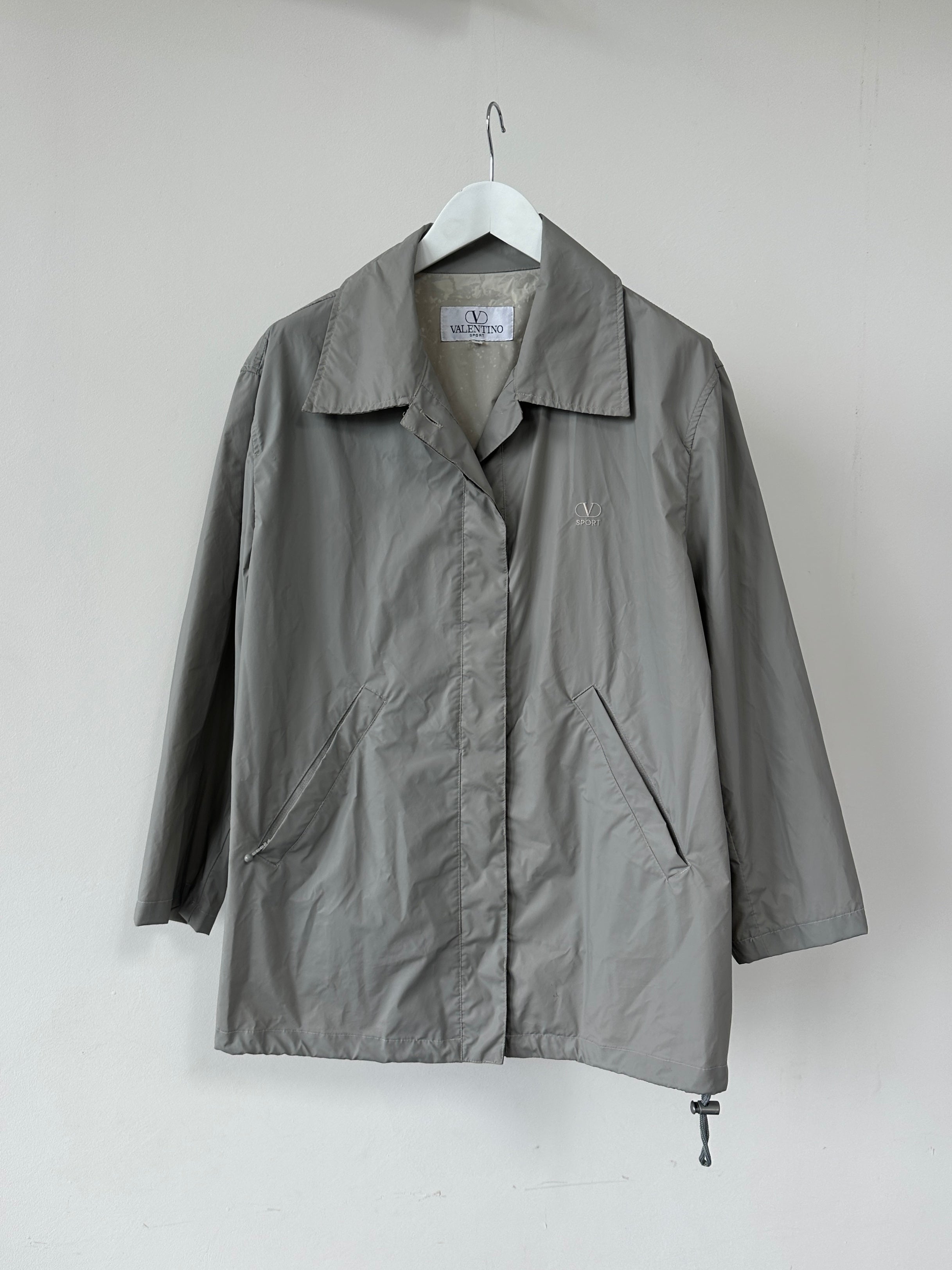 Valentino Sport raincoat jacket in size L, lightweight waterproof outerwear with a sleek design, shown on a hanger.