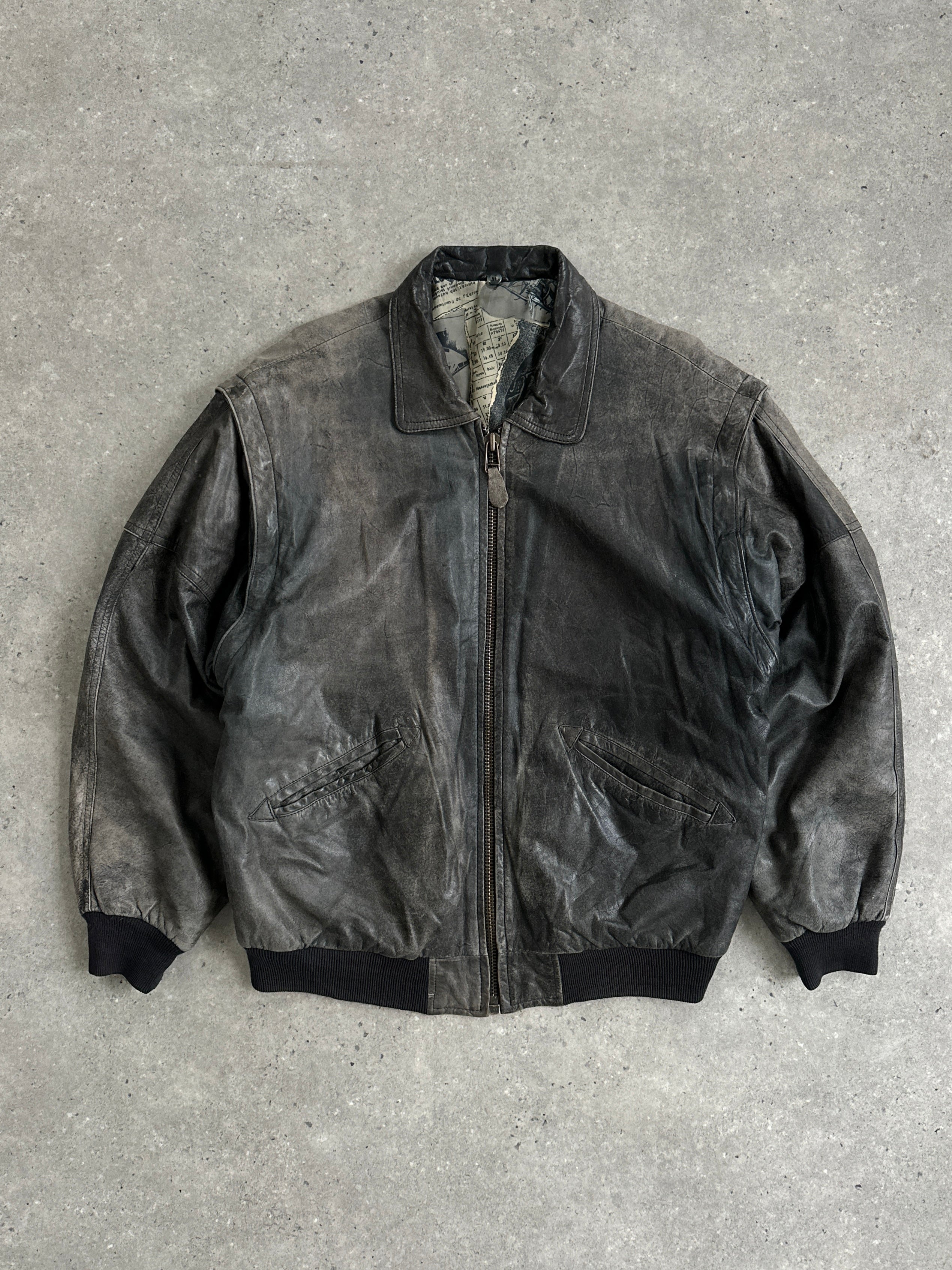 Vintage distressed leather bomber jacket in size L/XL, featuring a rugged, worn-in look with classic aviation-inspired style.