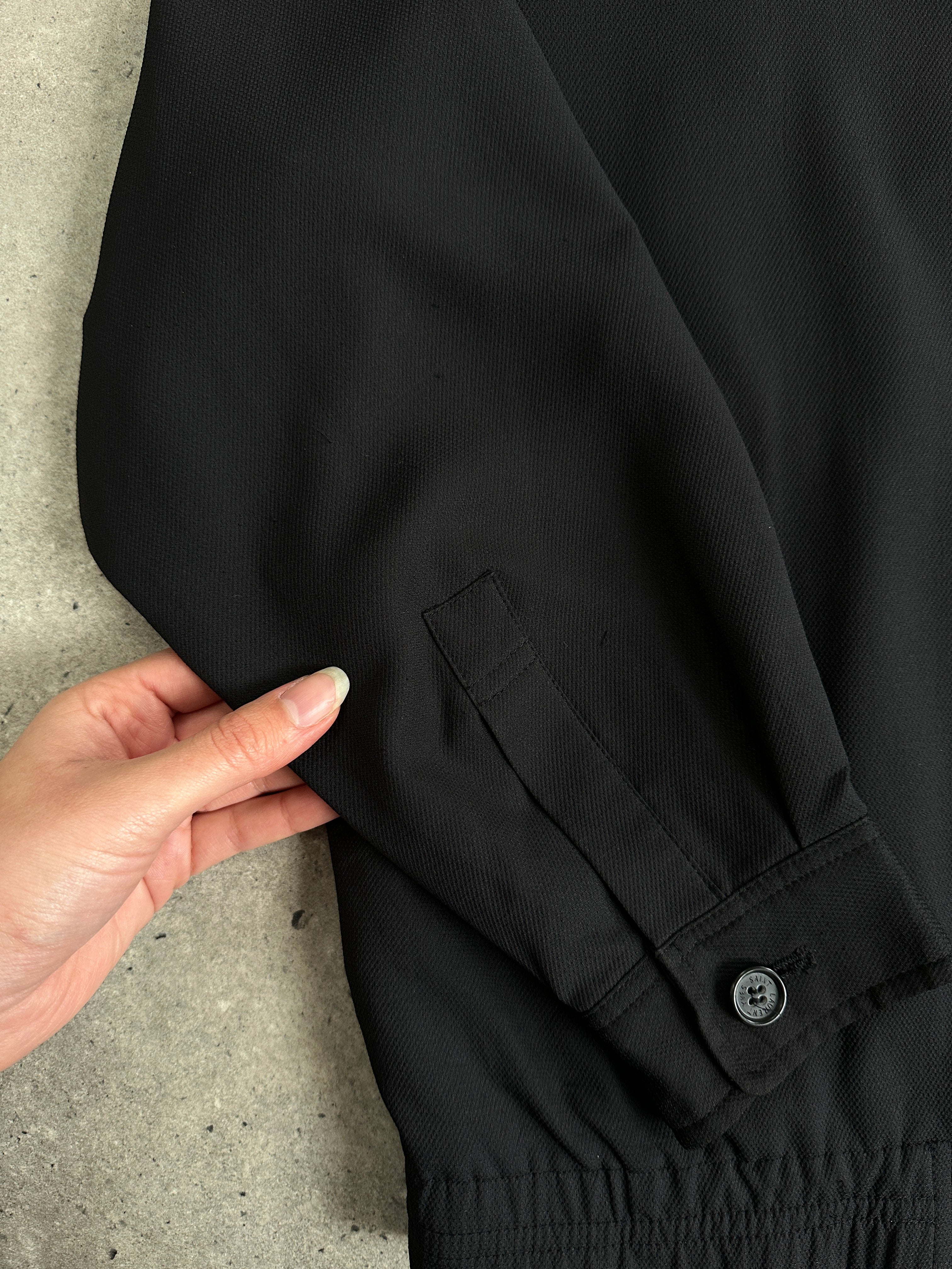 Yves Saint Laurent Pour Homme logo bomber jacket in size M, black with embroidered logo detail, front view.