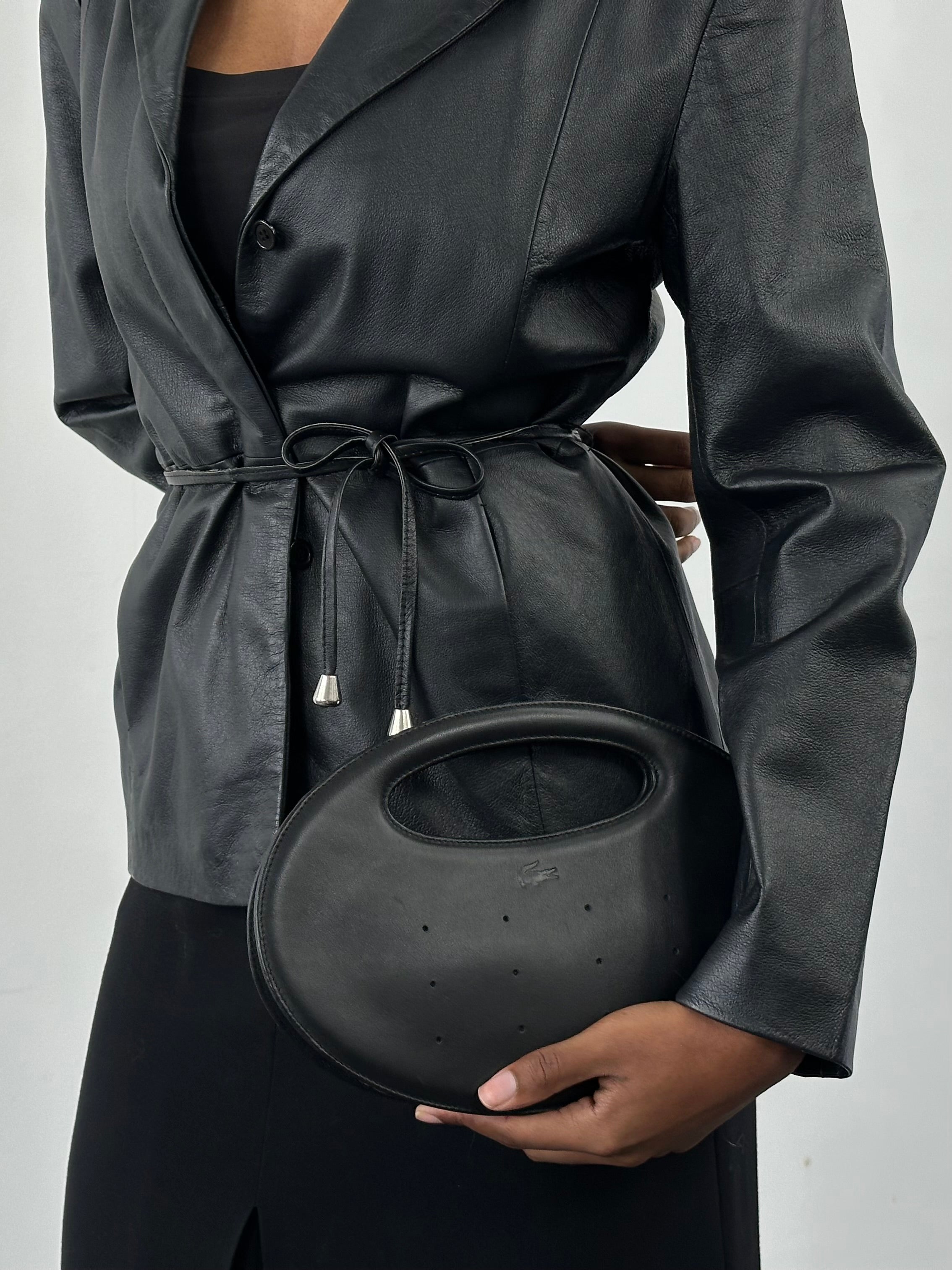 Lacoste 2000s faux leather oval handle bag with sleek design and sturdy handle, stylish accessory for casual or formal outfits.