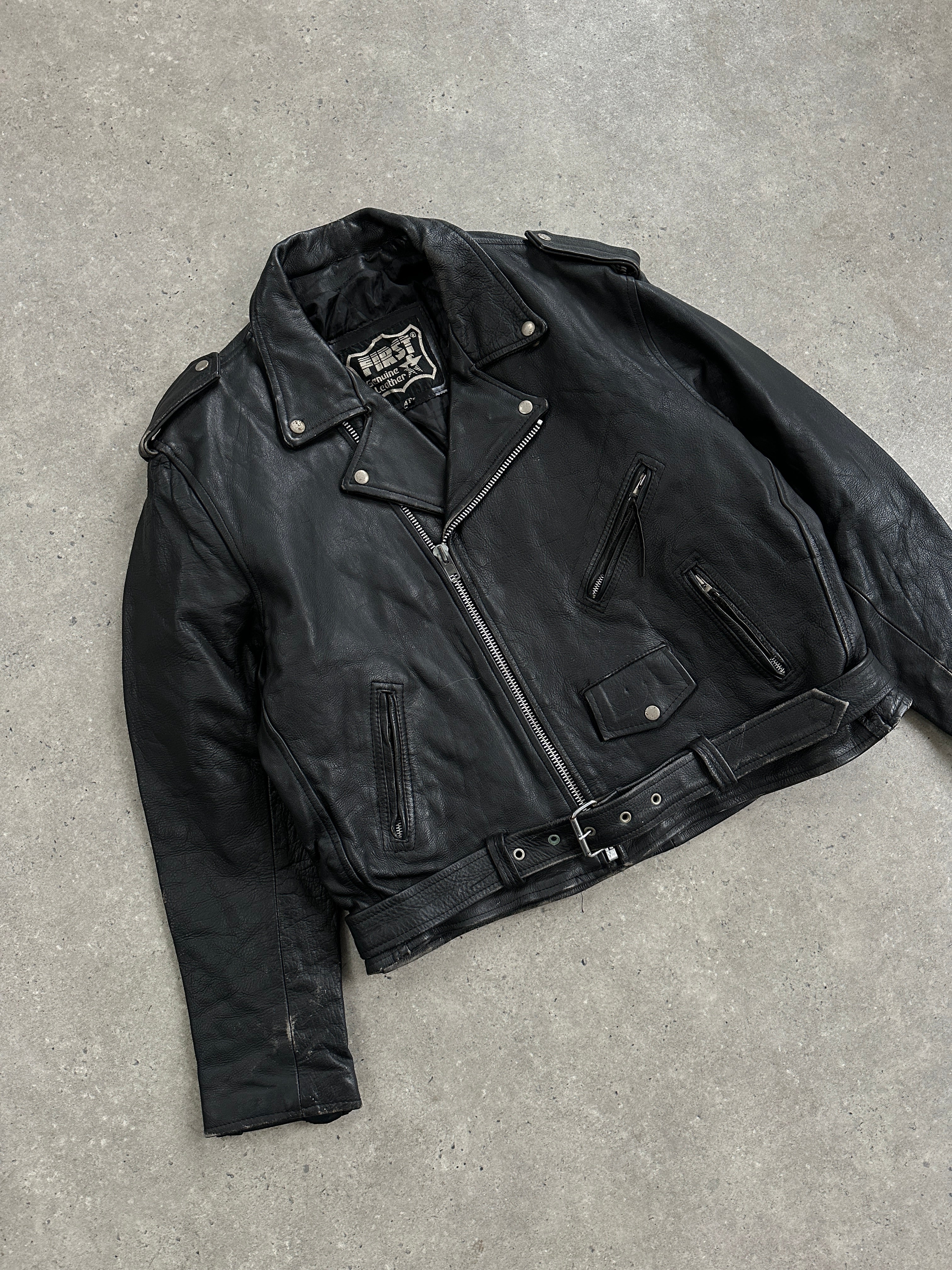 Vintage leather biker jacket in size XL, featuring classic design, metallic hardware, and distressed finish for a rugged look.