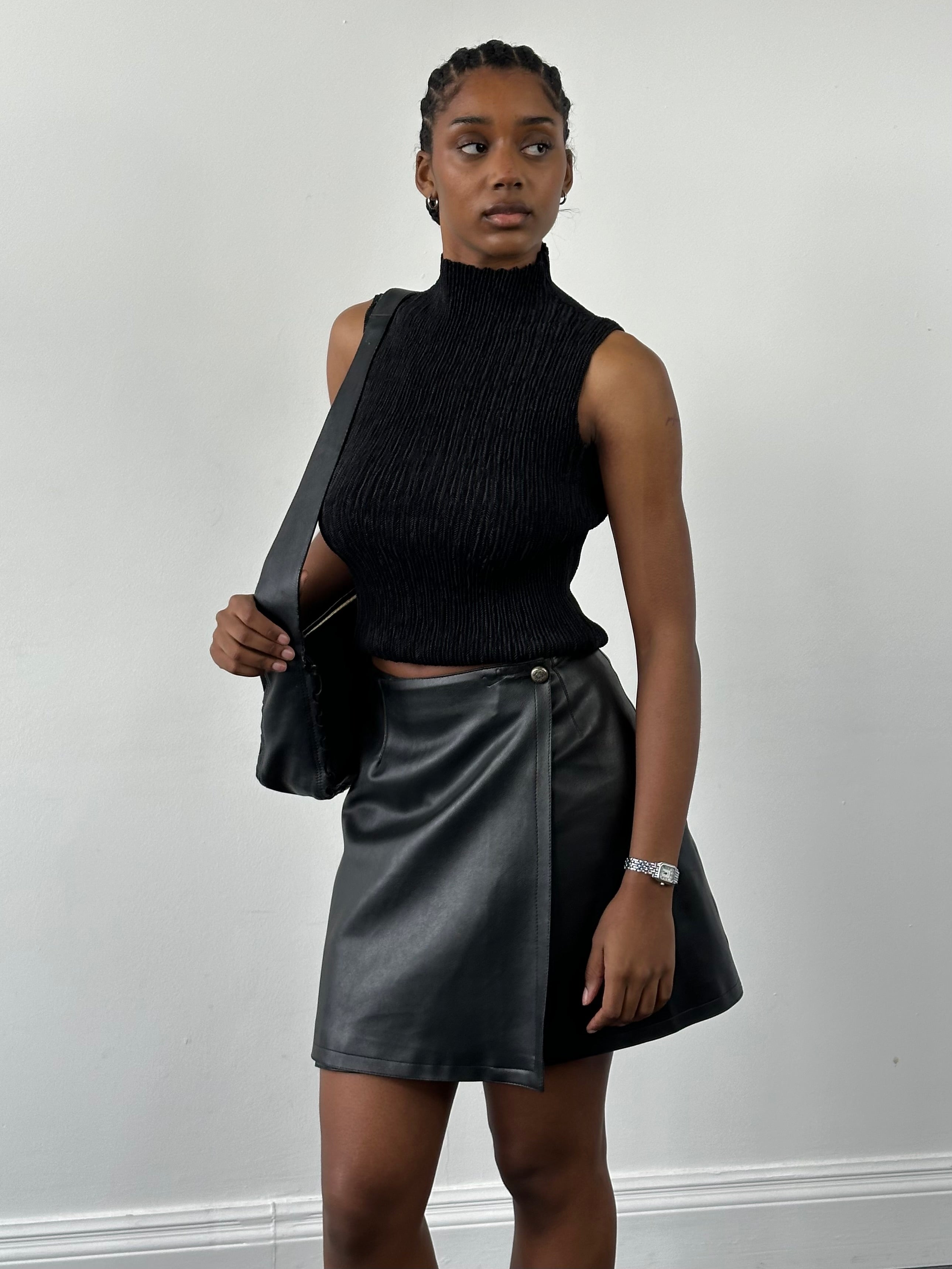 Vintage faux leather wrap mini skirt featuring a stylish design, shown in a close-up image highlighting the texture and fit.