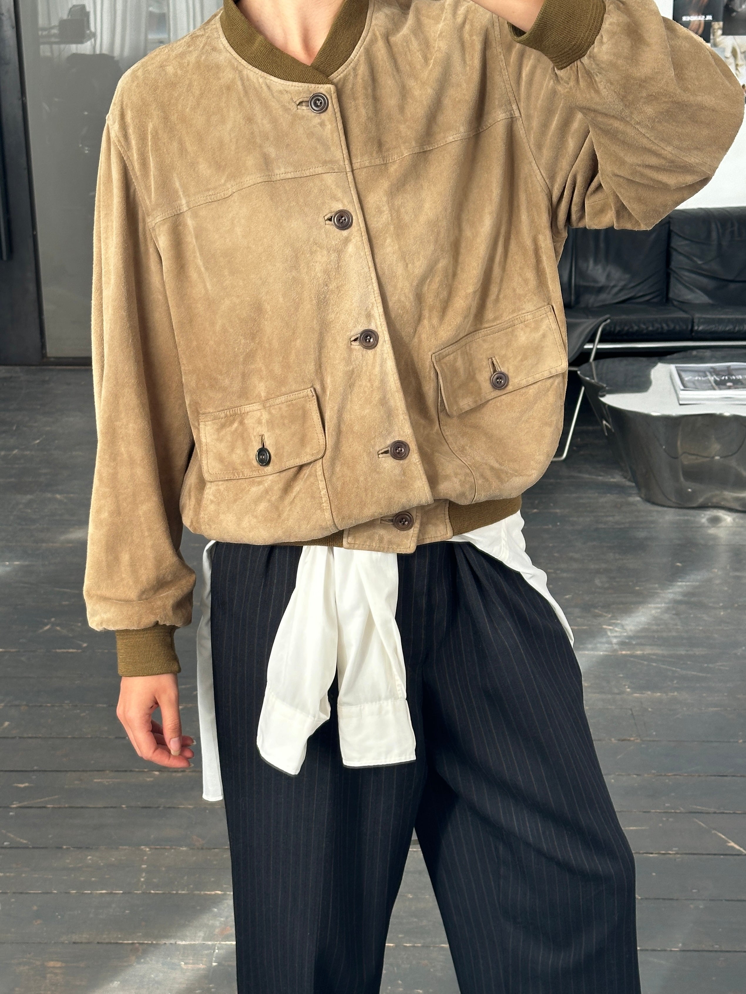 Vintage 1990s suede leather bomber jacket in size large, featuring classic design and textured tan suede fabric.