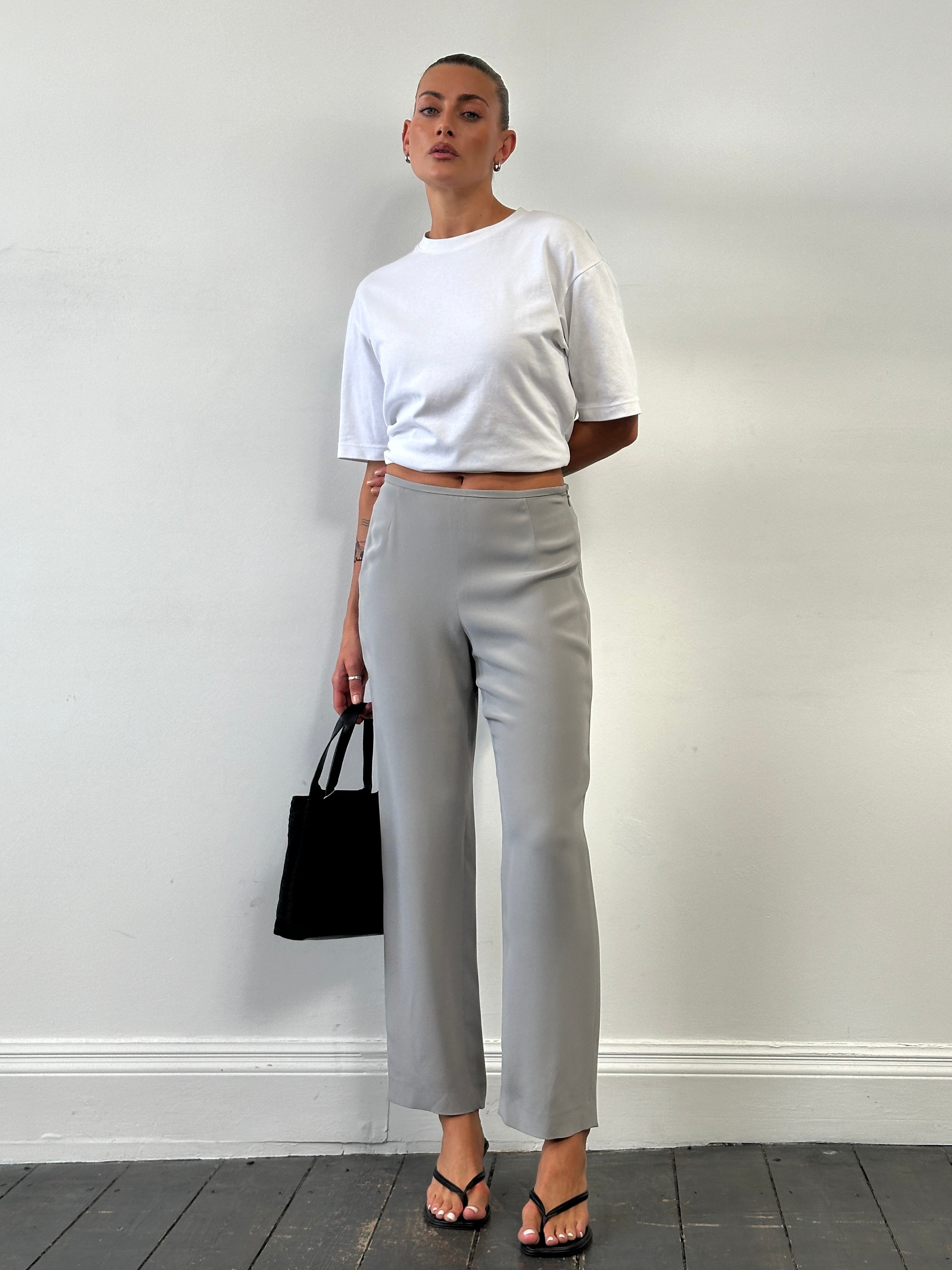 Armani Collezioni relaxed high-waisted silk trousers in W28, shown with a smooth, flowing fabric and tailored fit.