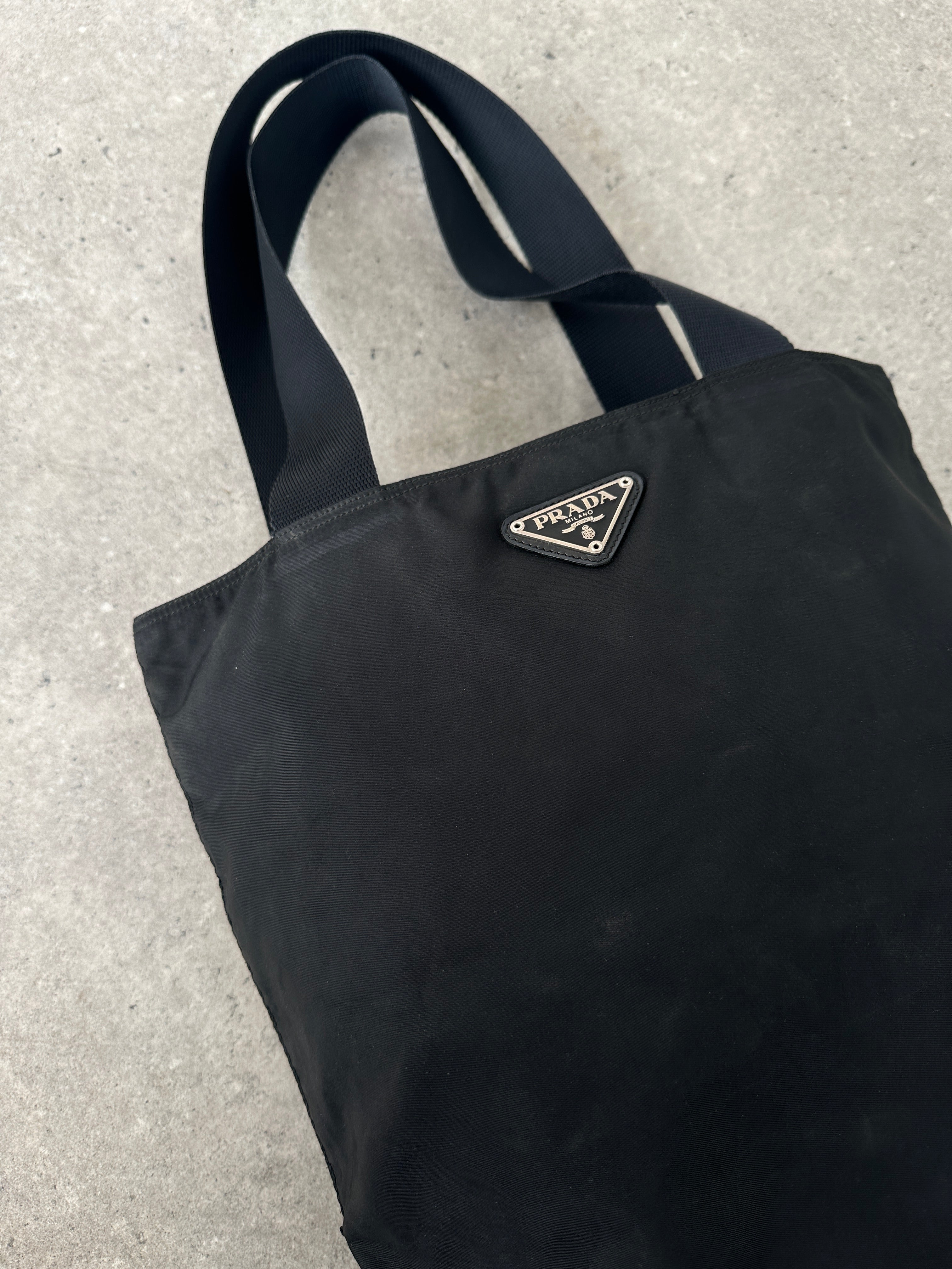 Prada 1997 Nylon Shoulder Bag showing navy blue nylon material with adjustable shoulder strap and Prada logo detail