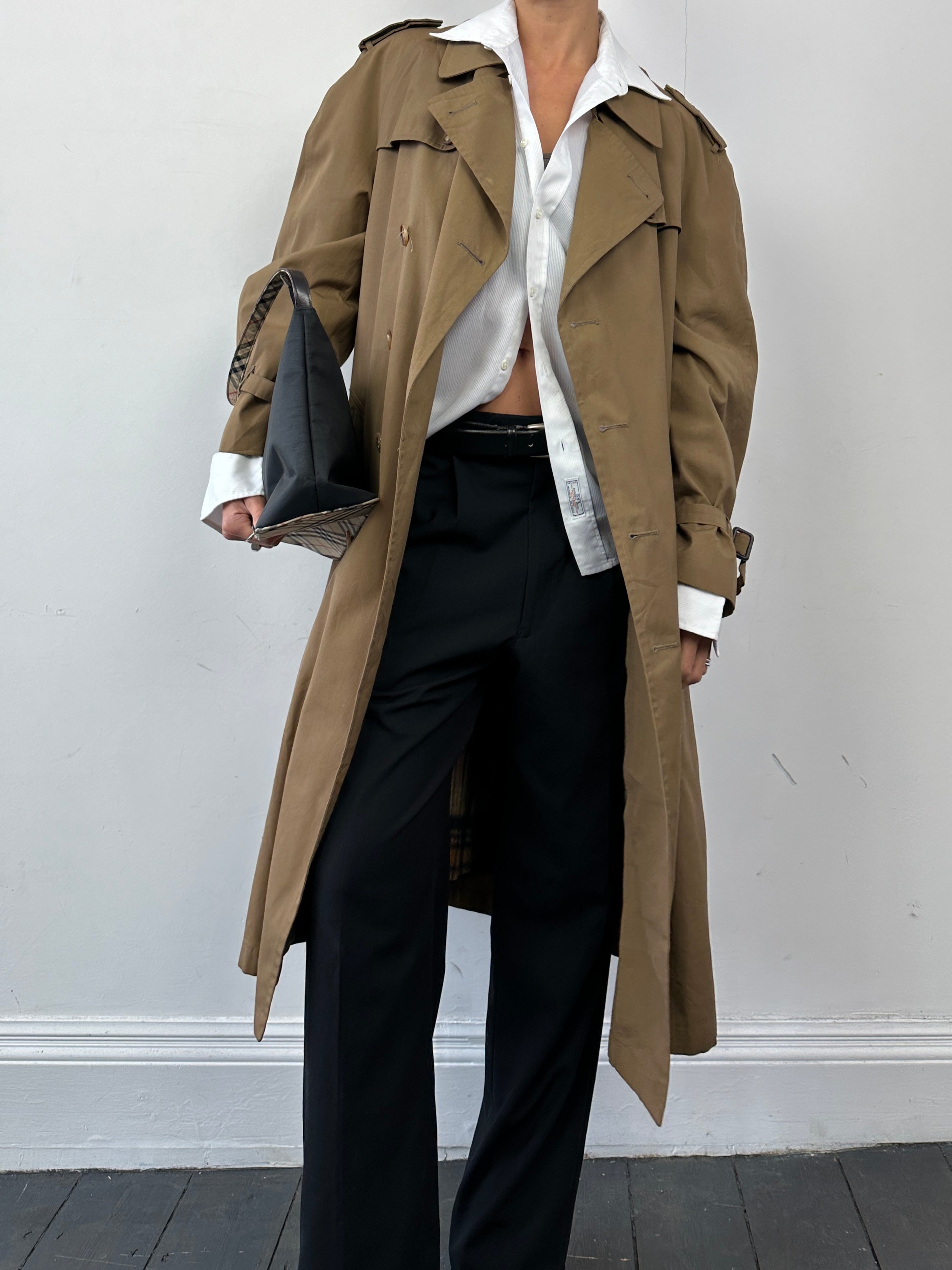 Christian Dior cotton double-breasted trench coat in size L, shown on a mannequin with classic beige color and stylish design.