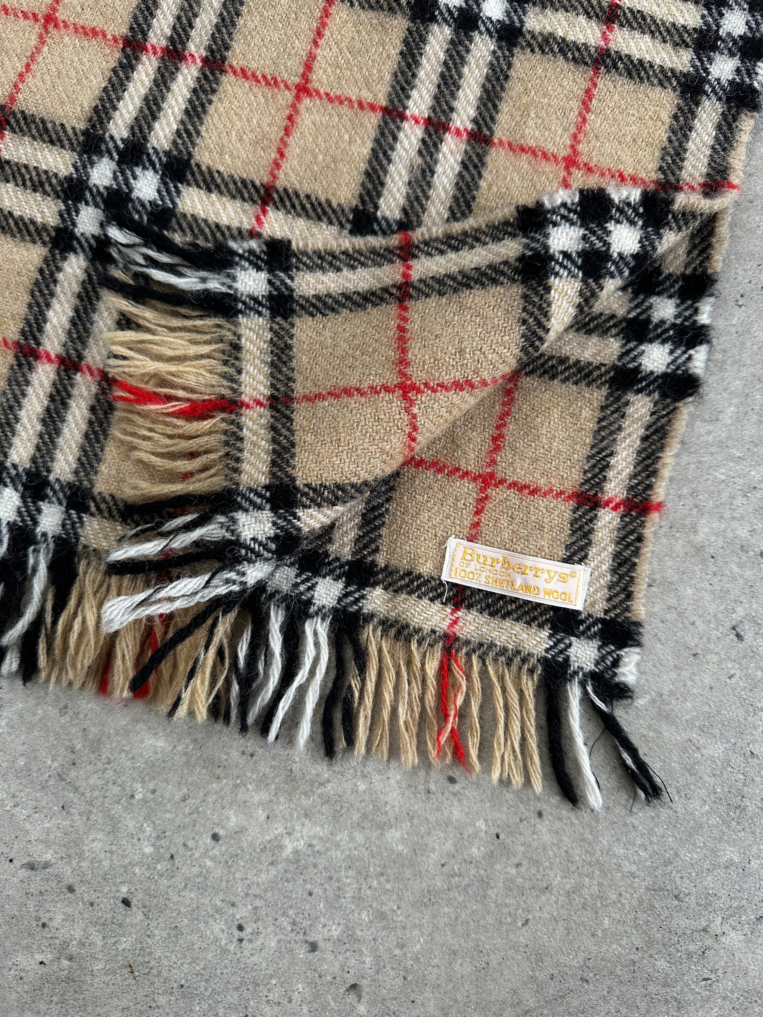 Burberry Lambswool Cashmere Nova Check Scarf featuring classic plaid pattern in beige, black, and red for stylish warmth.