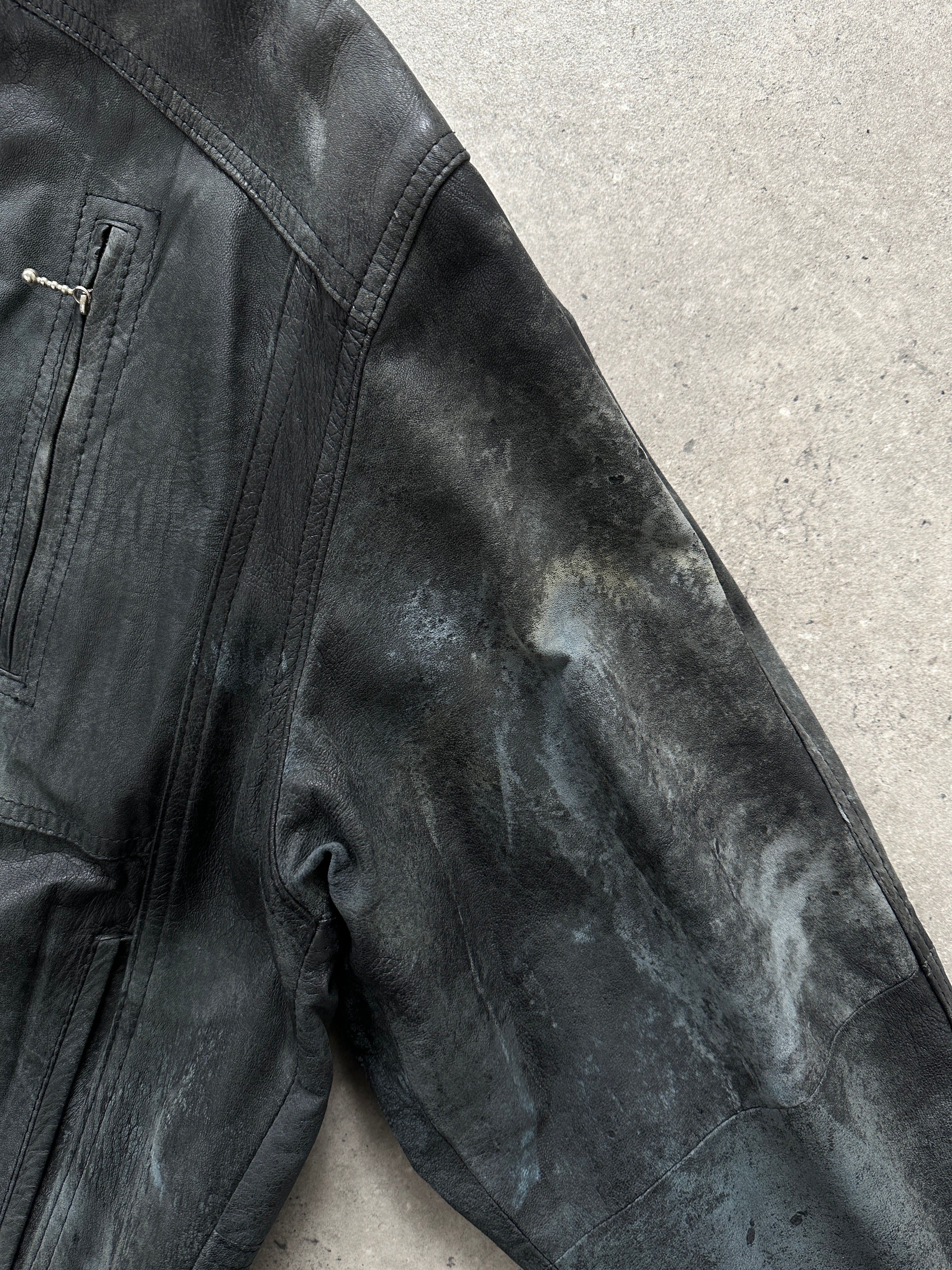 Vintage distressed marbled leather jacket in size M, showcasing rugged texture and stylish design.