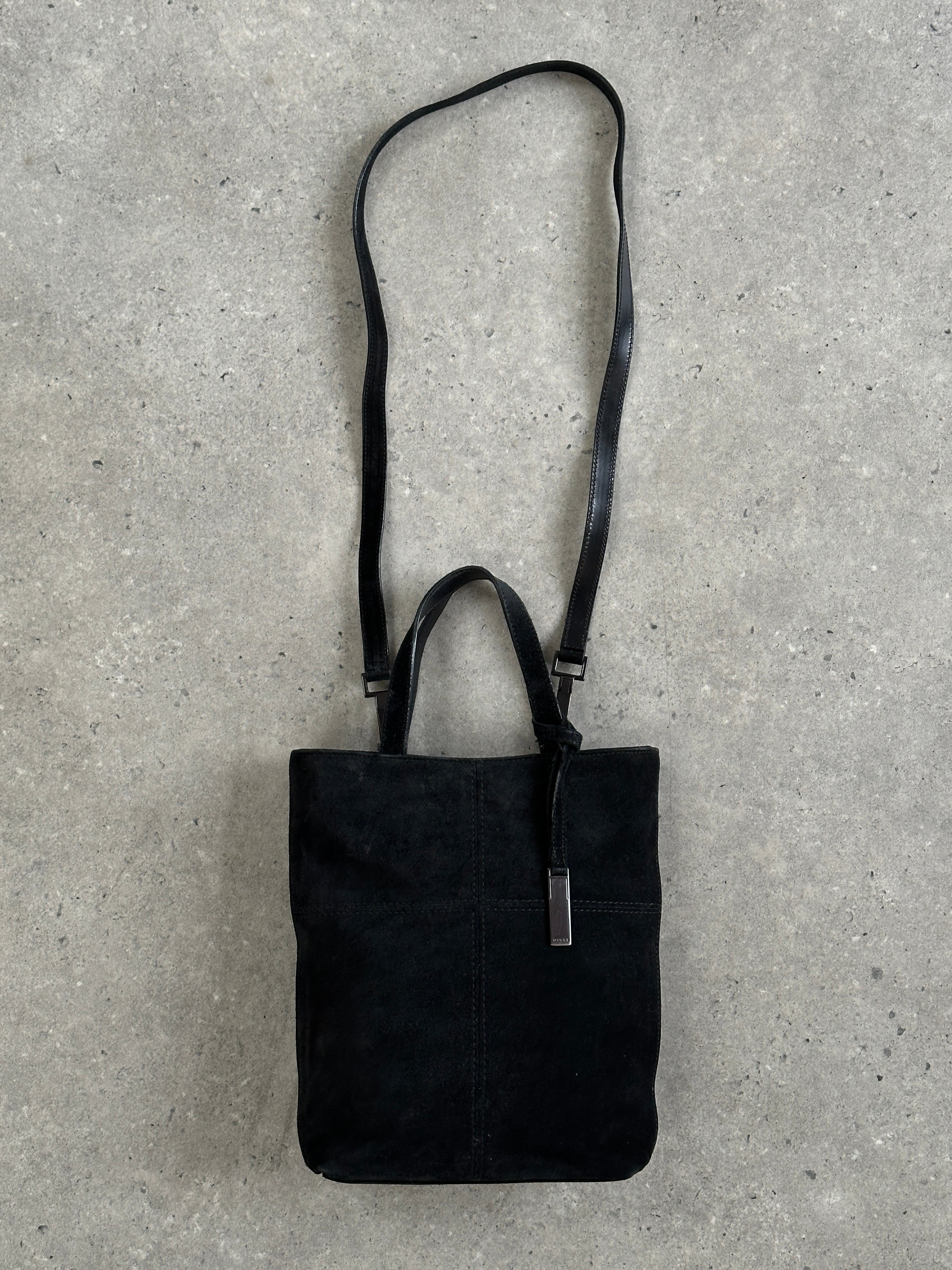 Gucci 2000s suede top handle crossbody bag with sleek design and adjustable strap, featuring signature branding and elegant craftsmanship.