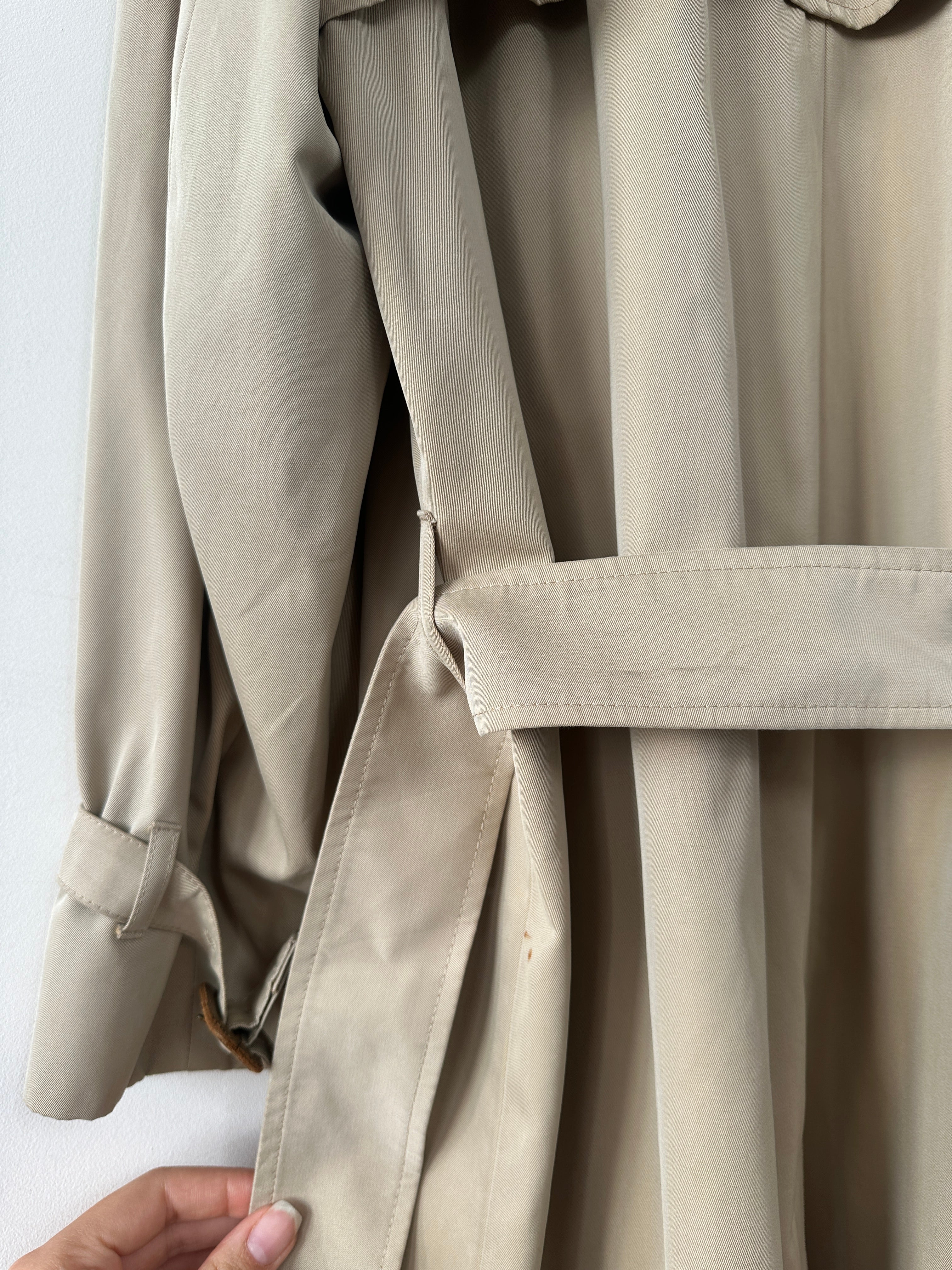Aquascutum pure cotton trench coat with concealed placket and belted waist, in classic design, shown in natural fabric texture.