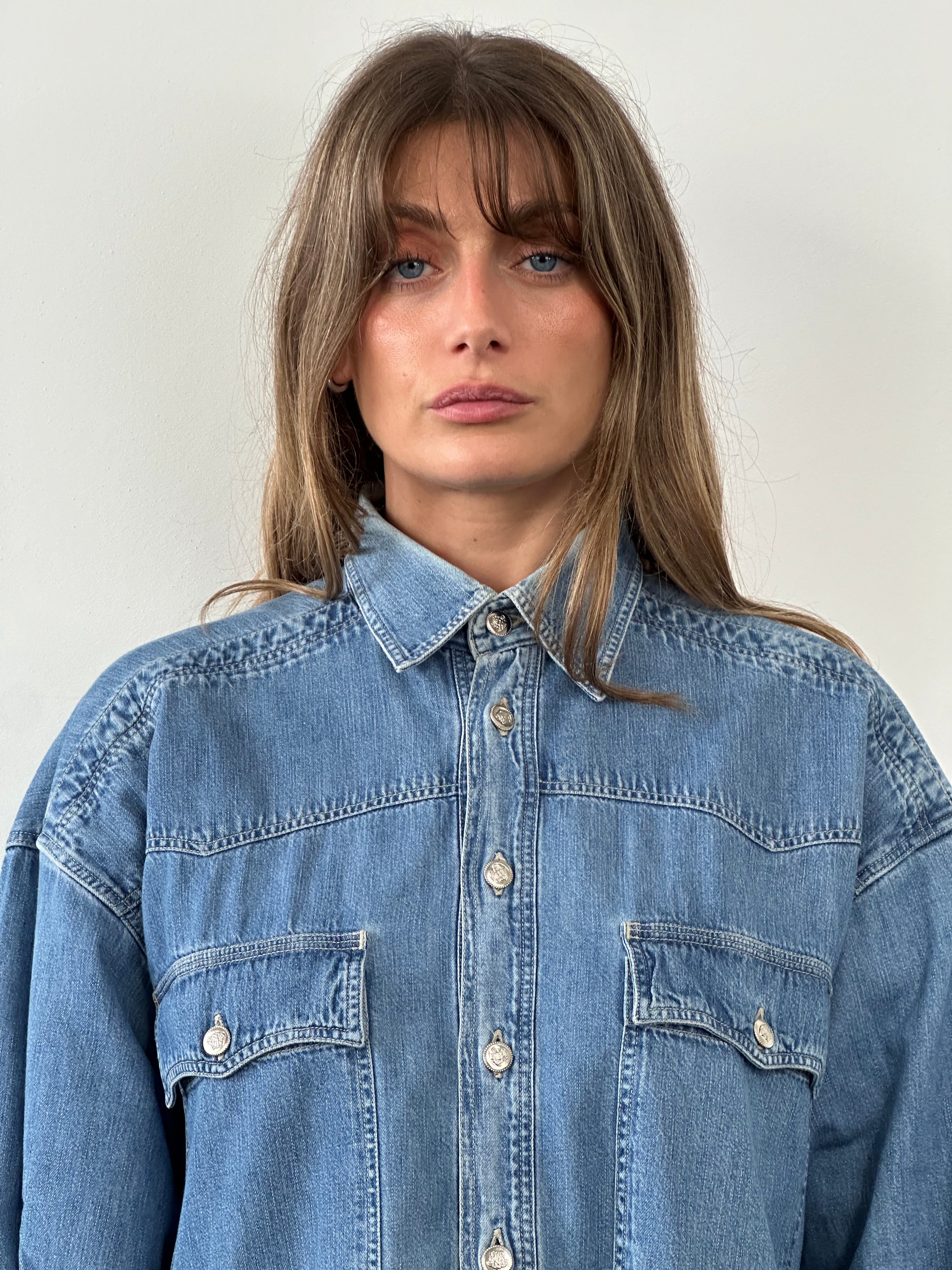 Versace Medusa button denim shirt in size XL, featuring classic denim fabric and Medusa logo buttons, displayed on a hanger.