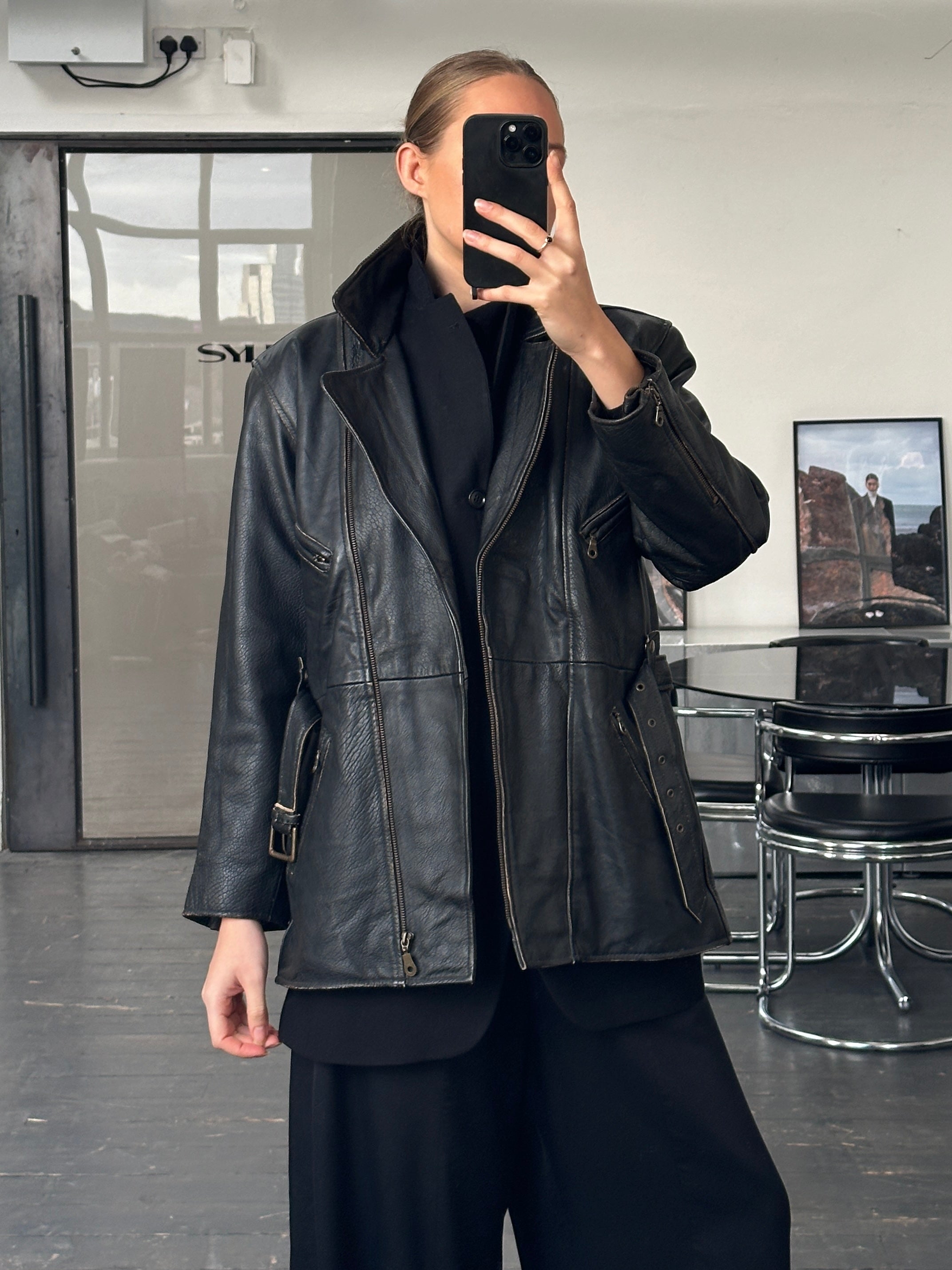 Vintage 1980s aviator belted leather jacket in size M/L, featuring classic design and rugged leather texture.