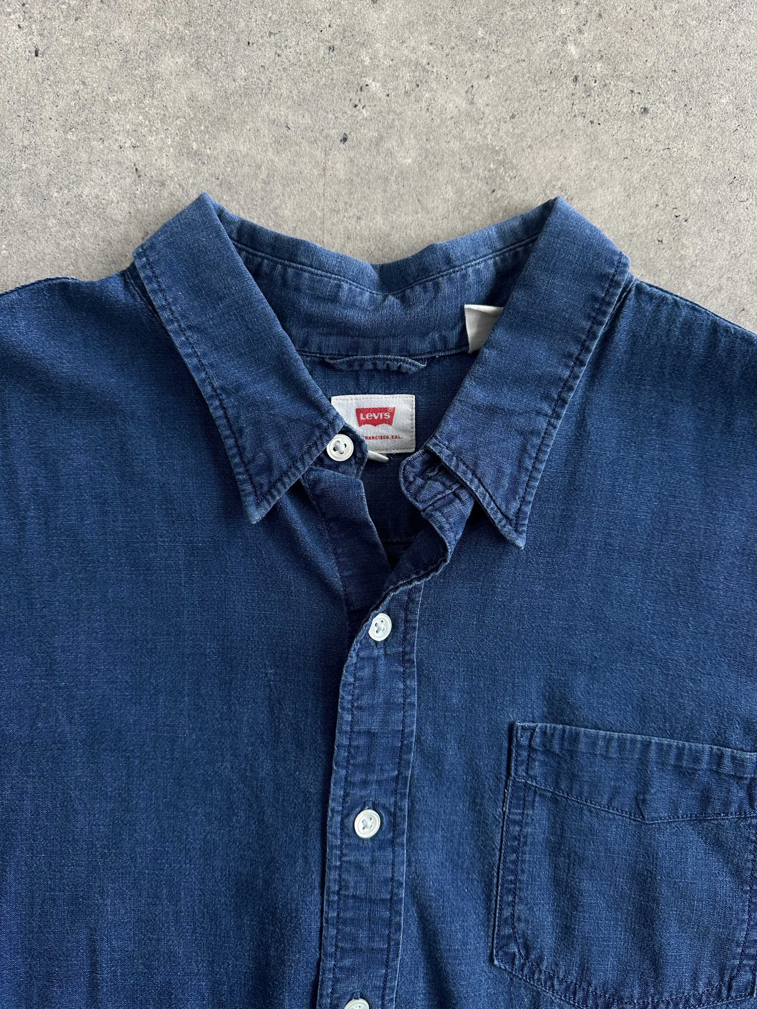 Levi’s Pure Cotton denim shirt in XL, showcasing classic blue denim with button-down front and long sleeves.