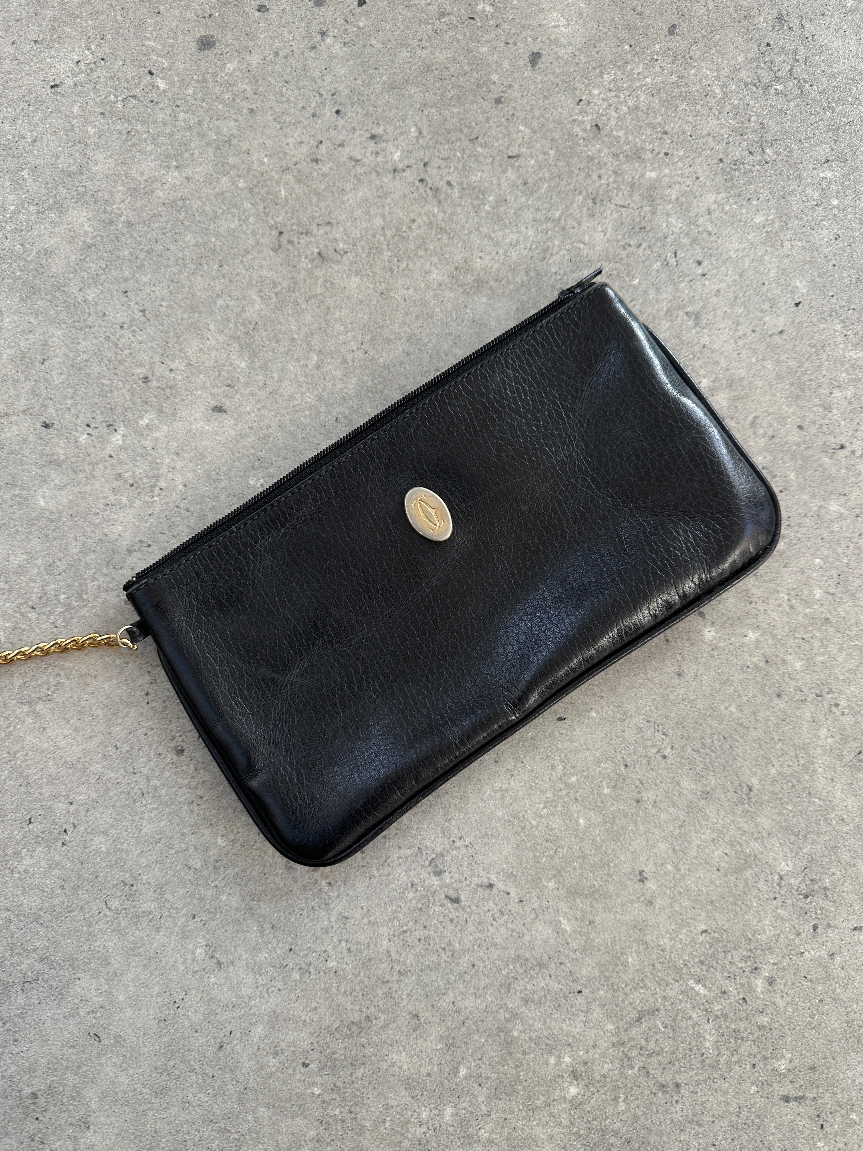 Cartier 1980s leather bucket bag with adjustable strap and classic design, featuring the brand's signature style and craftsmanship.