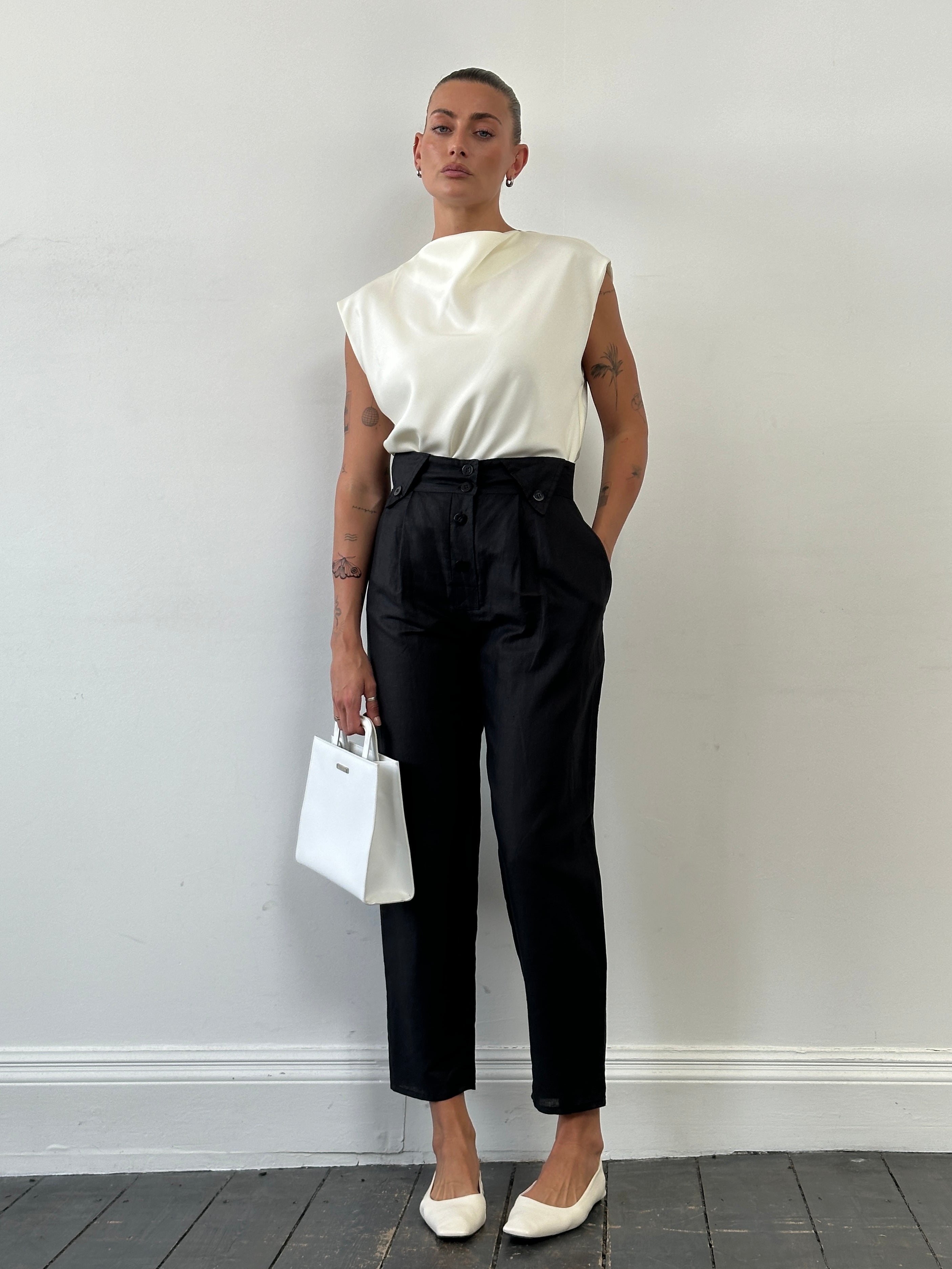 Vintage high waisted tapered trousers in W26 style, featuring classic vintage design and tailored fit, shown in the image.
