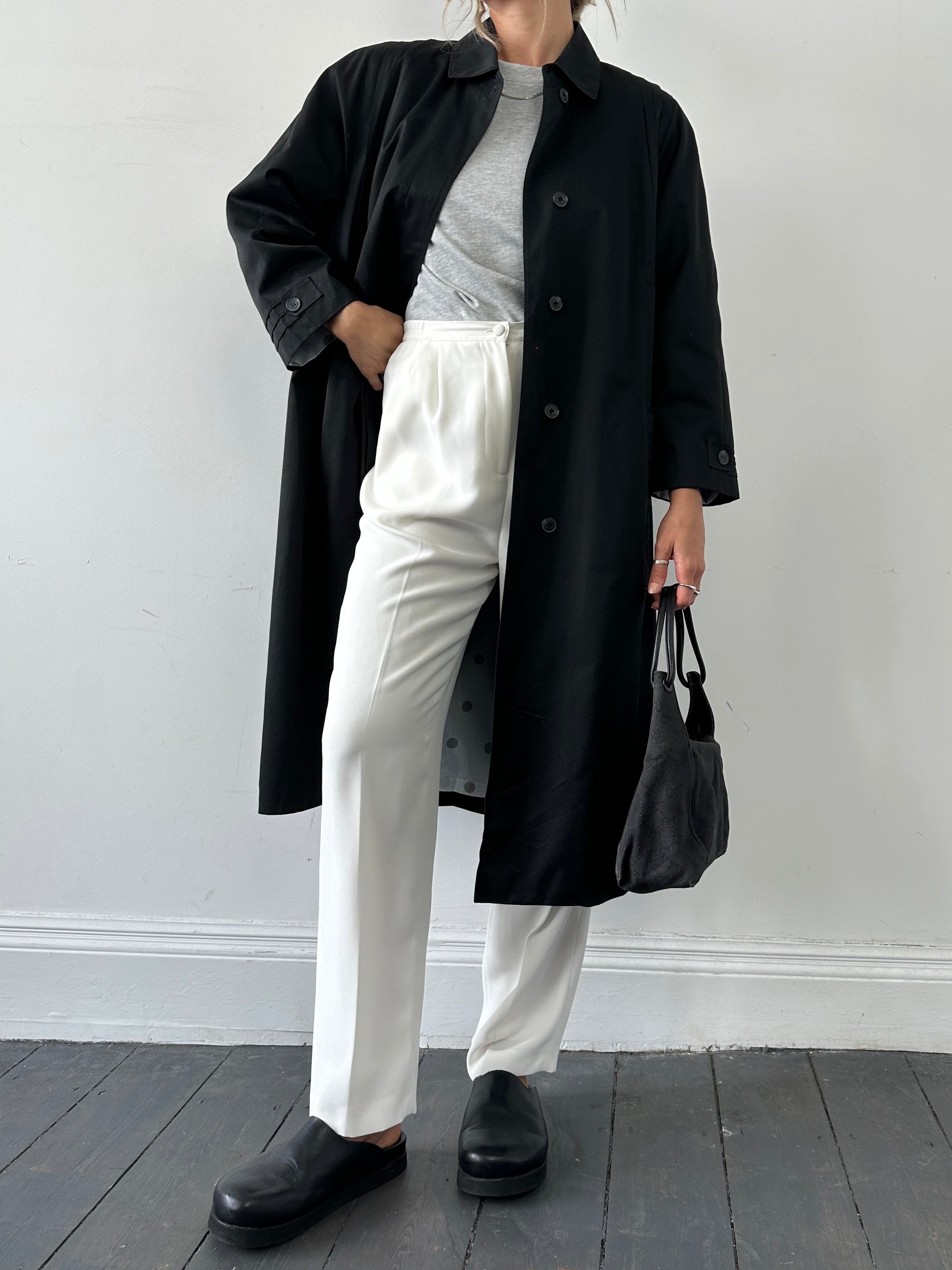 Vintage brand vintage pleated cotton trench coat in size M, featuring classic design and durable fabric, displayed on a hanger.