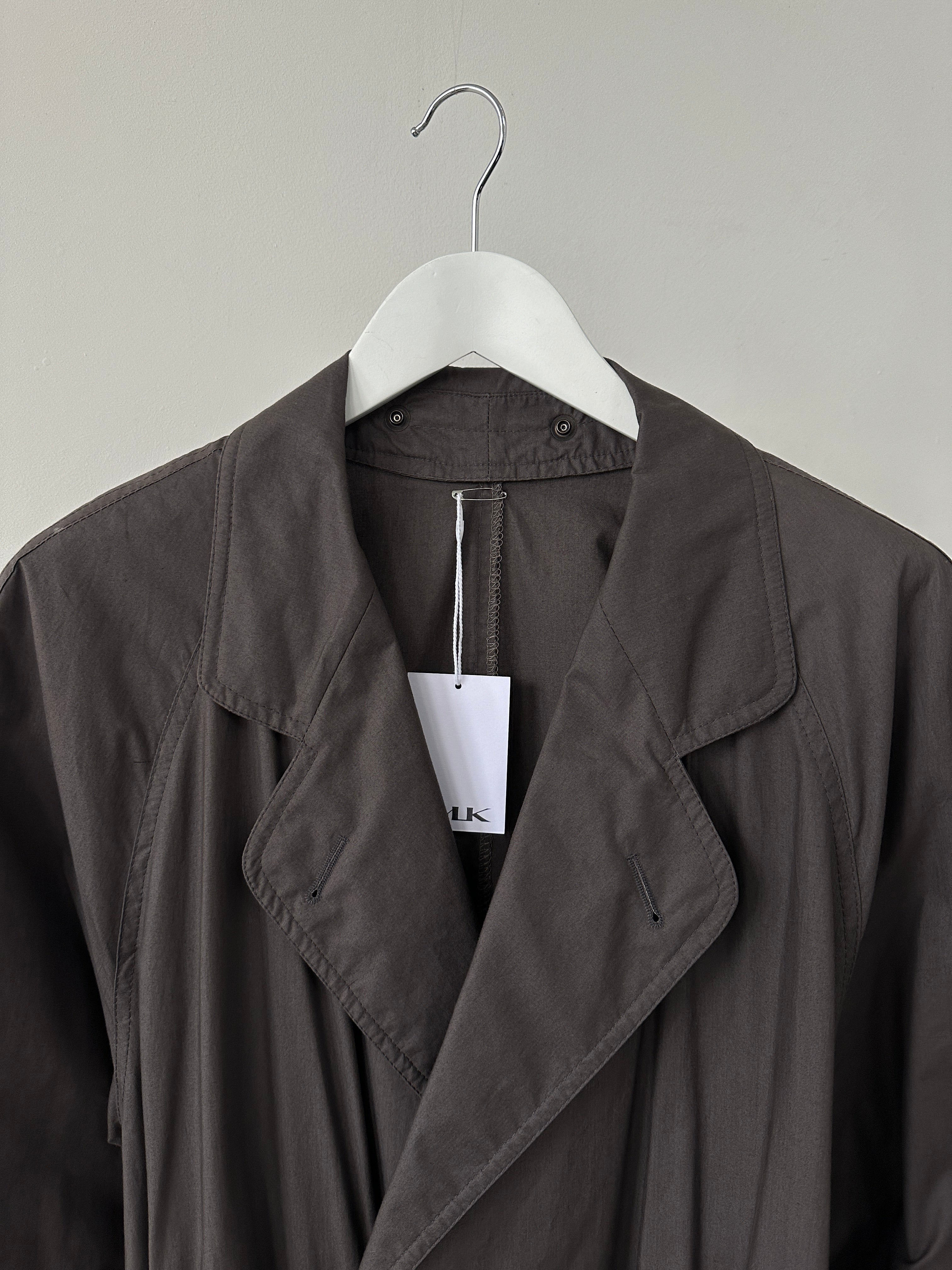 Vintage double-breasted unlined belted trench coat in size L, featuring classic design and lightweight fabric.