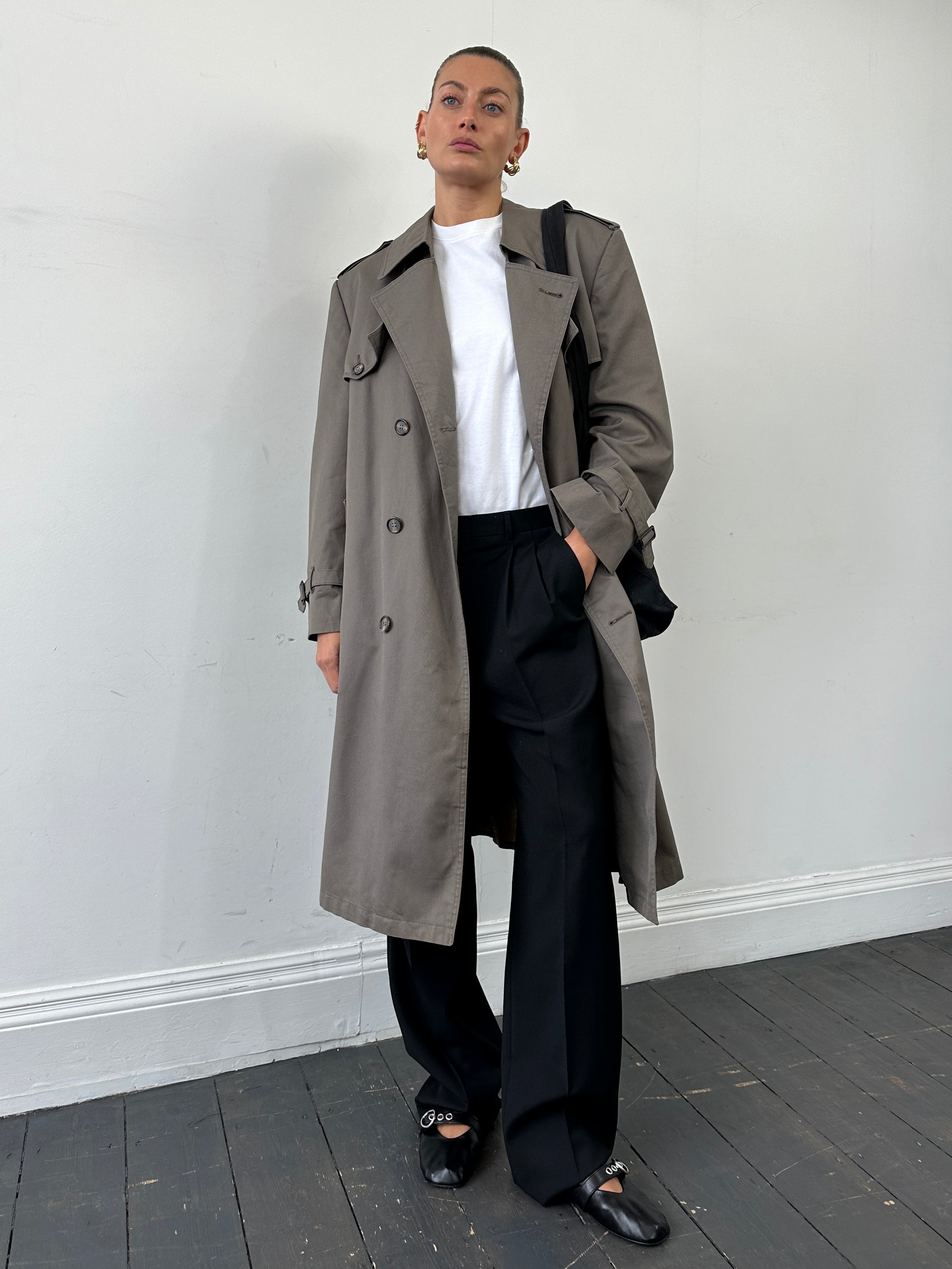 Christian Dior Monsieur double-breasted belted trench coat in classic beige, displayed on a hanger.