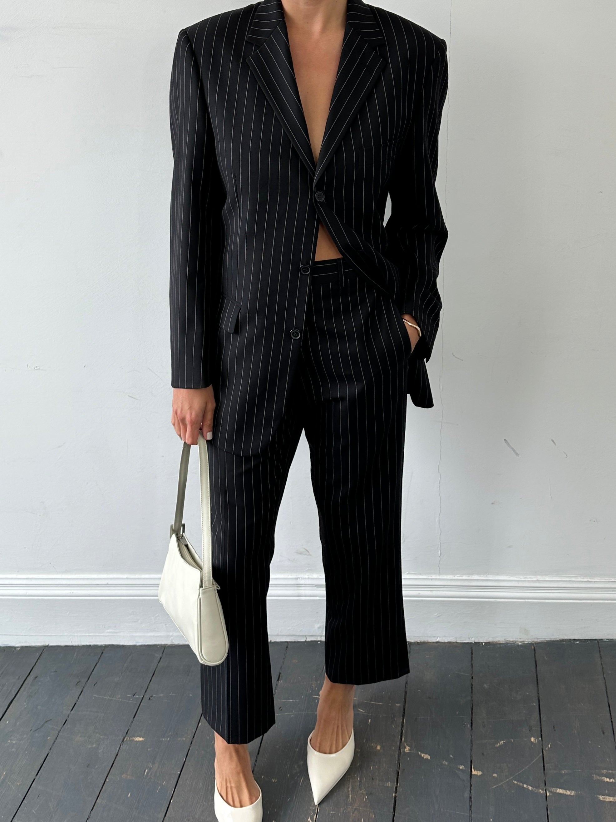 Yves Saint Laurent pour Homme pinstripe pure wool single-breasted suit in size 38S/W28, displayed on a hanger.