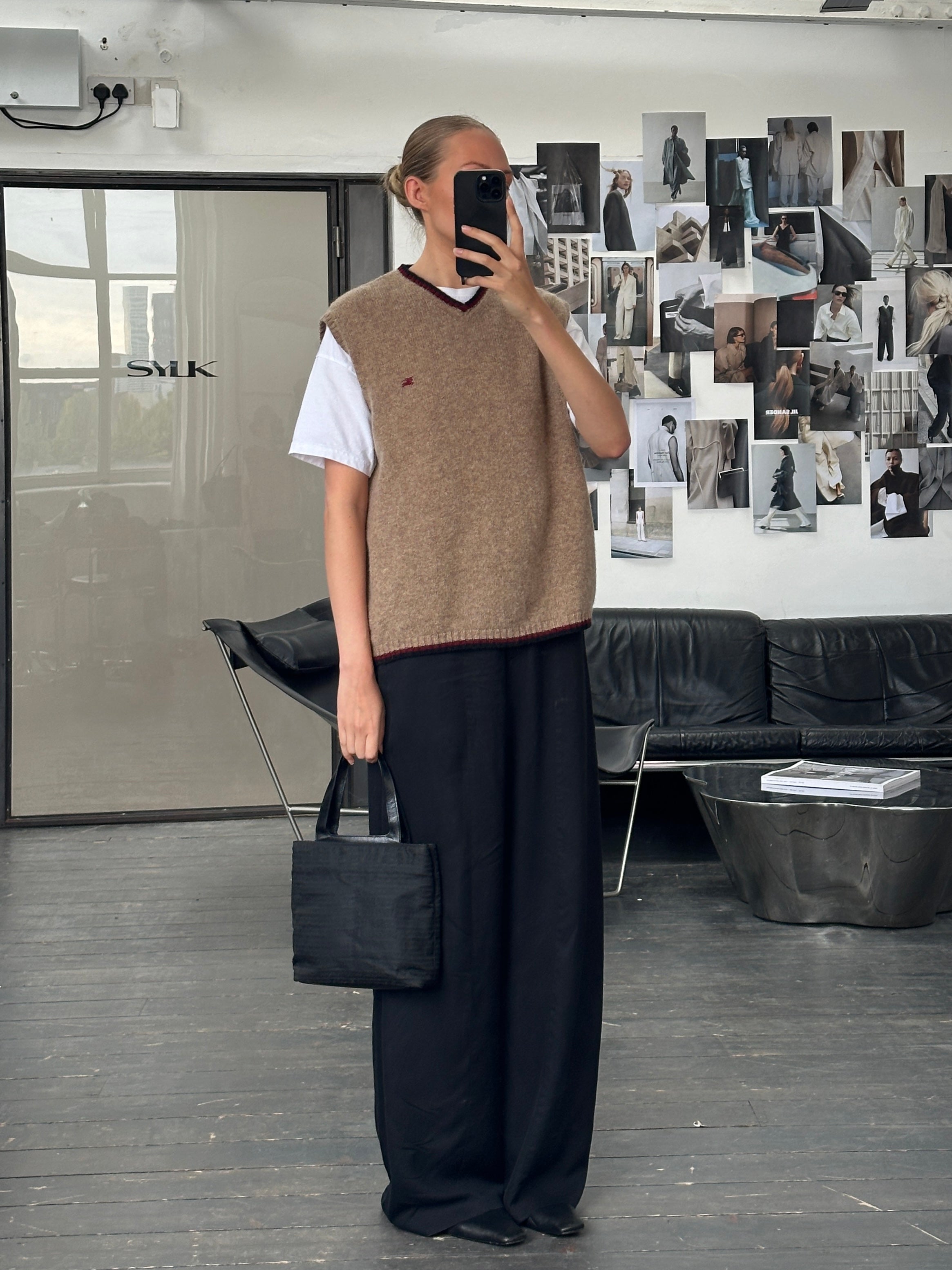 Burberry London 2000s pure wool sleeveless logo knitted jumper in size M/L, showing the beige wool fabric and signature logo.