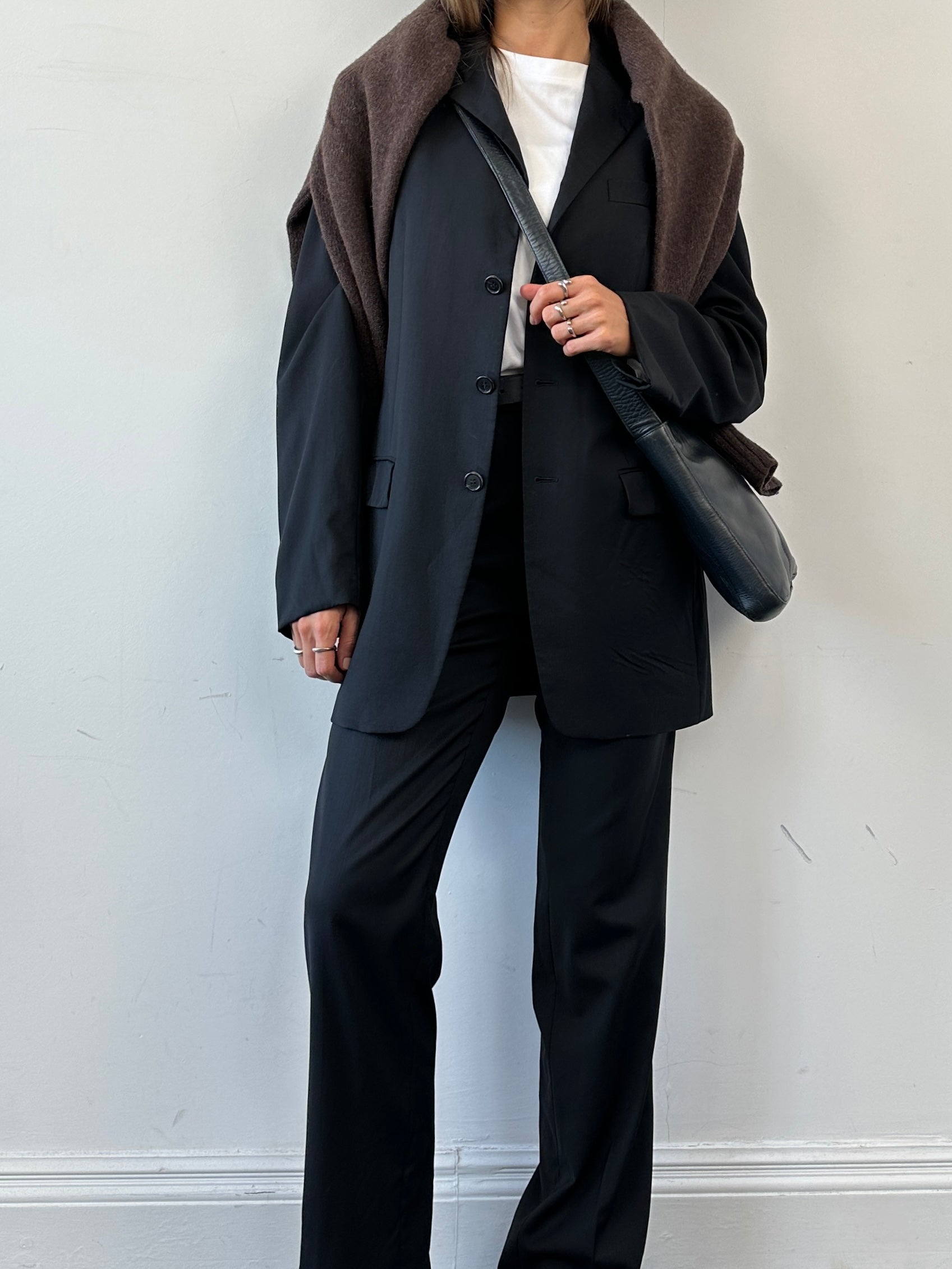 Prada virgin wool jumpsuit in mid-rise, single-breasted design, size 40L/W28, tailored with a sleek, elegant fit.
