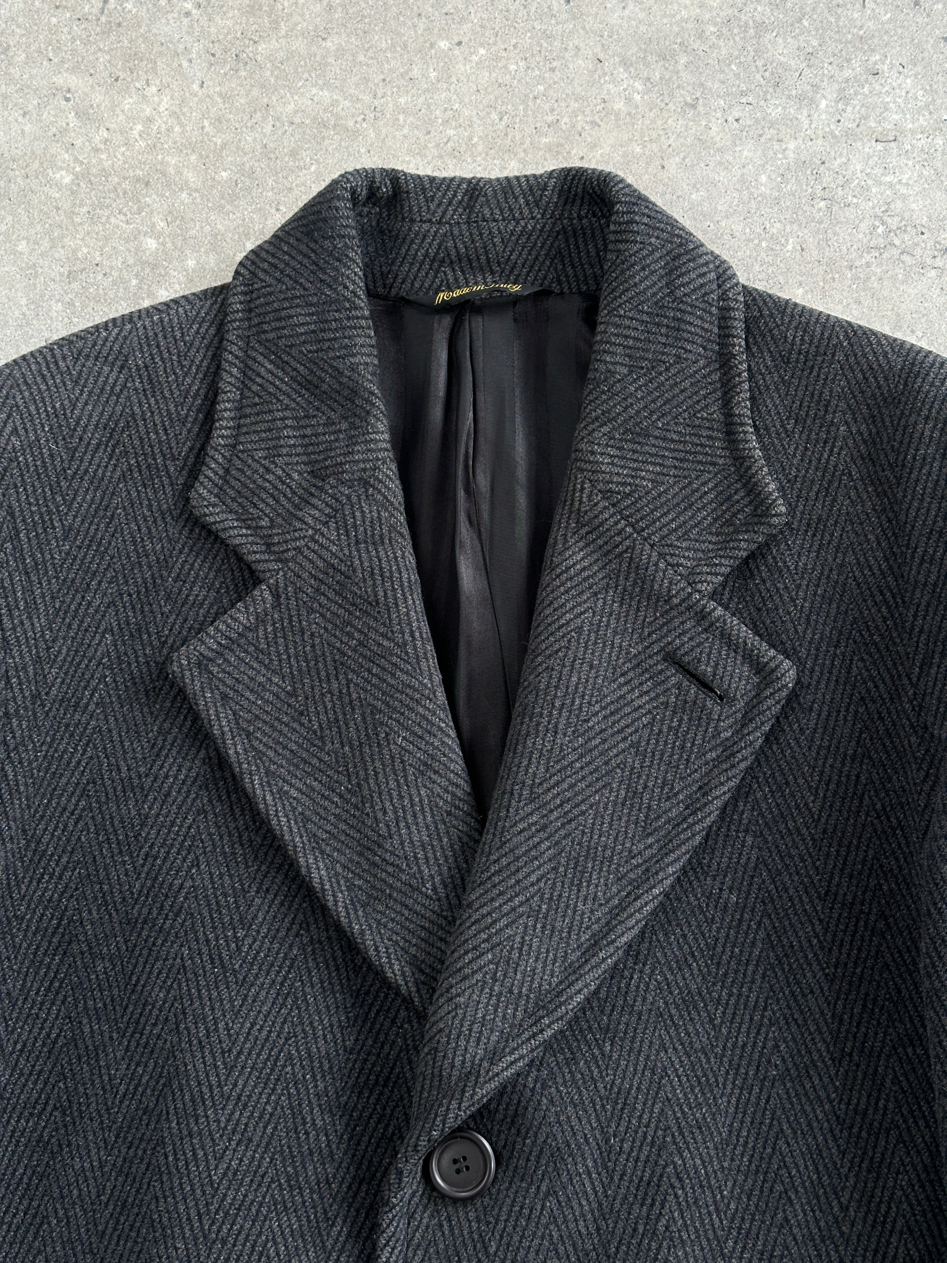 Vintage Italian 1980s wool cashmere herringbone coat in XL, showcasing classic tailored design and textured fabric.