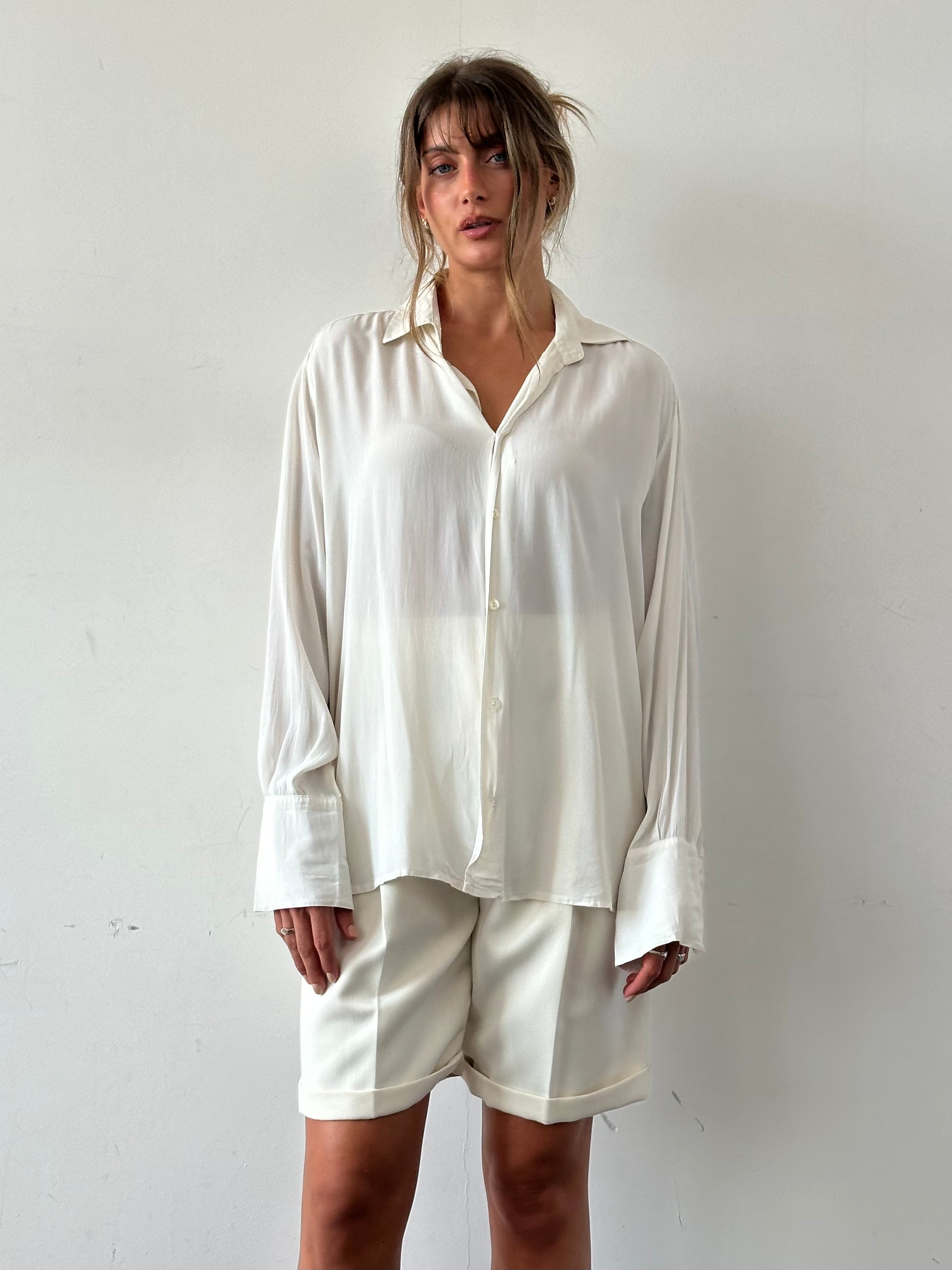 Vintage silk flowy shirt in size L, featuring a relaxed fit and elegant drape, perfect for casual or dressy occasions.