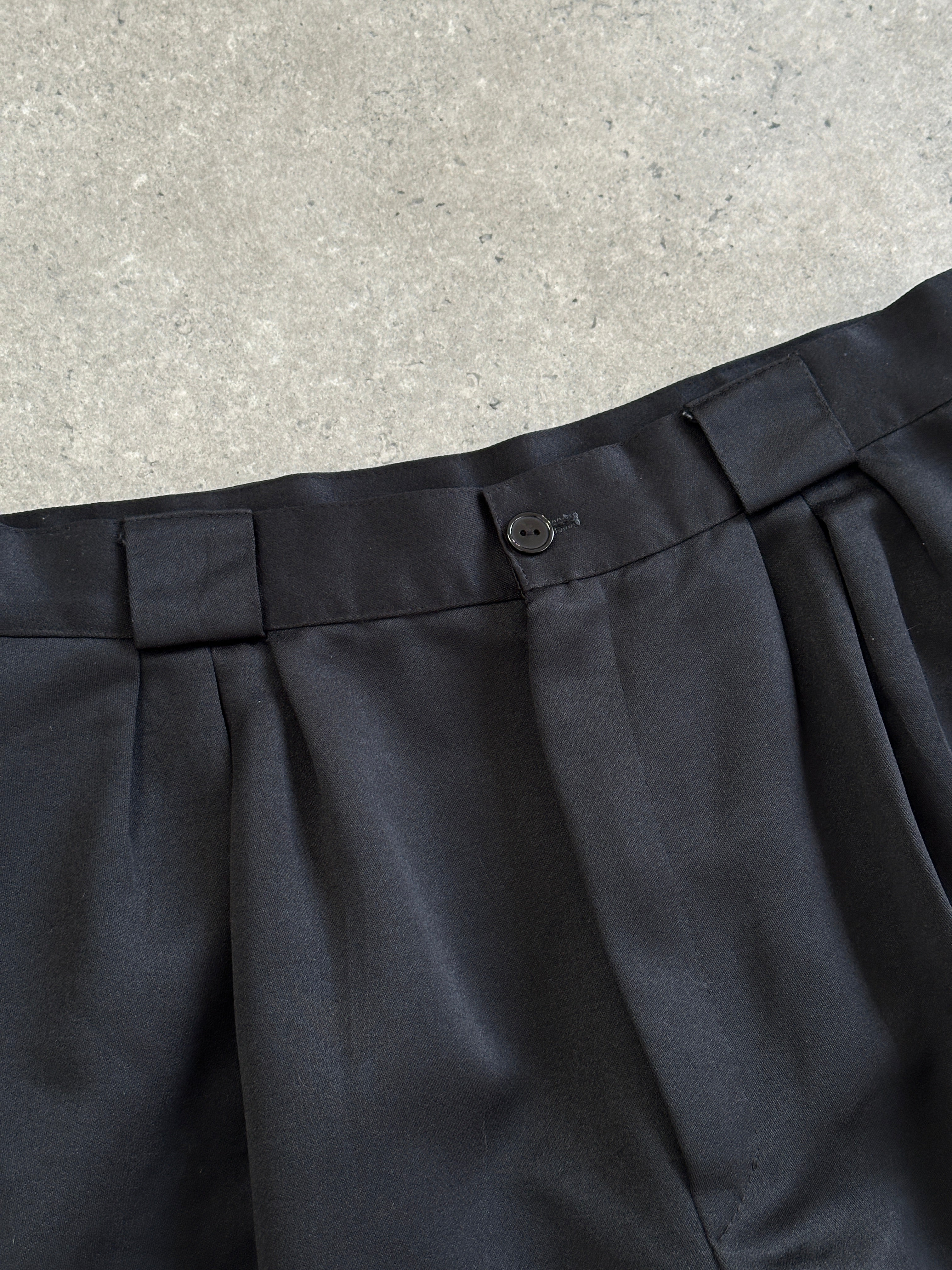 Vintage 1980s satin tapered leg high-waisted trousers in size W26, featuring a sleek, retro style with a polished finish.