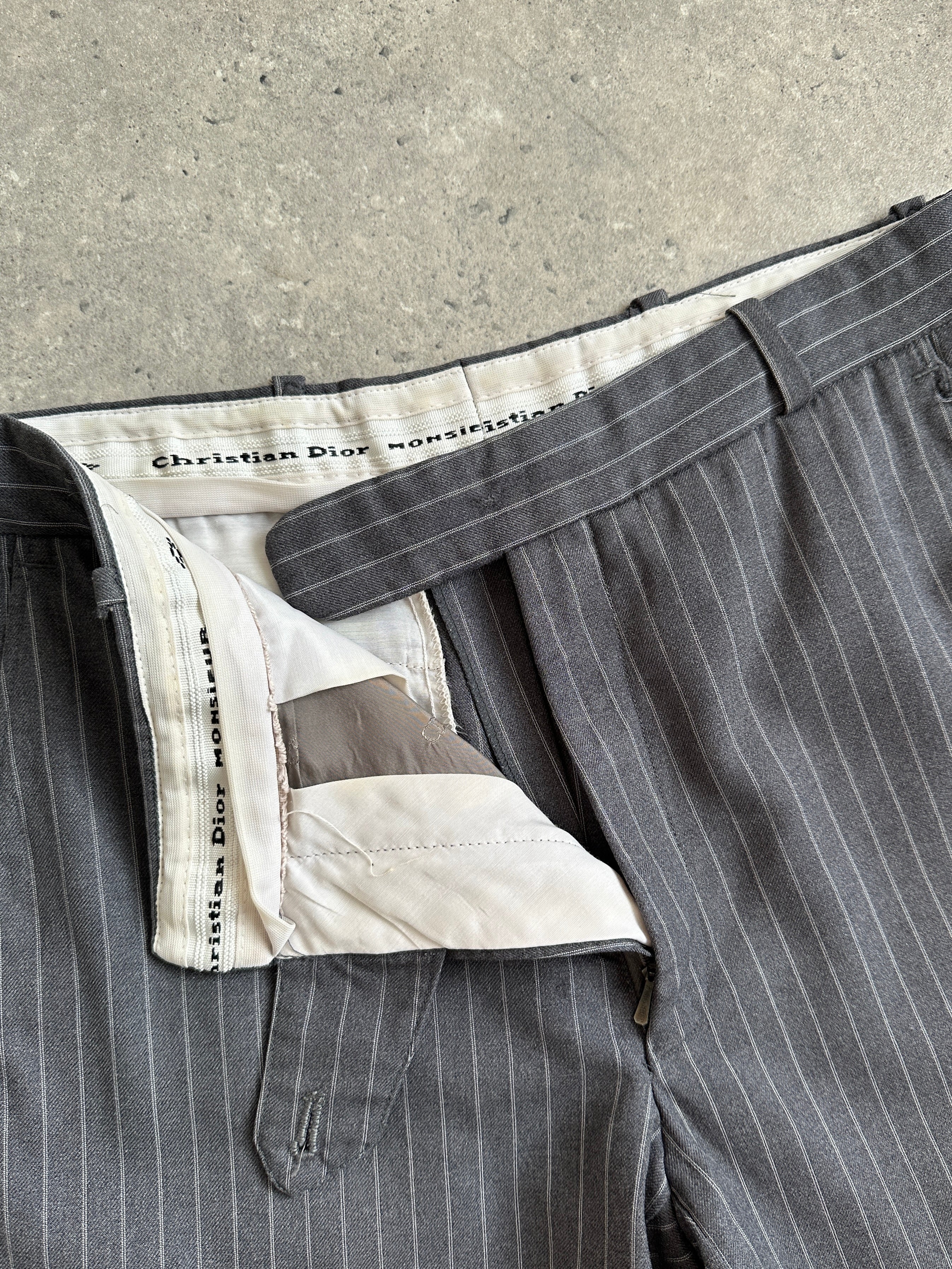 Christian Dior pinstripe wool mid-waist straight-leg trousers with belt loops, front pockets, and tailored fit.