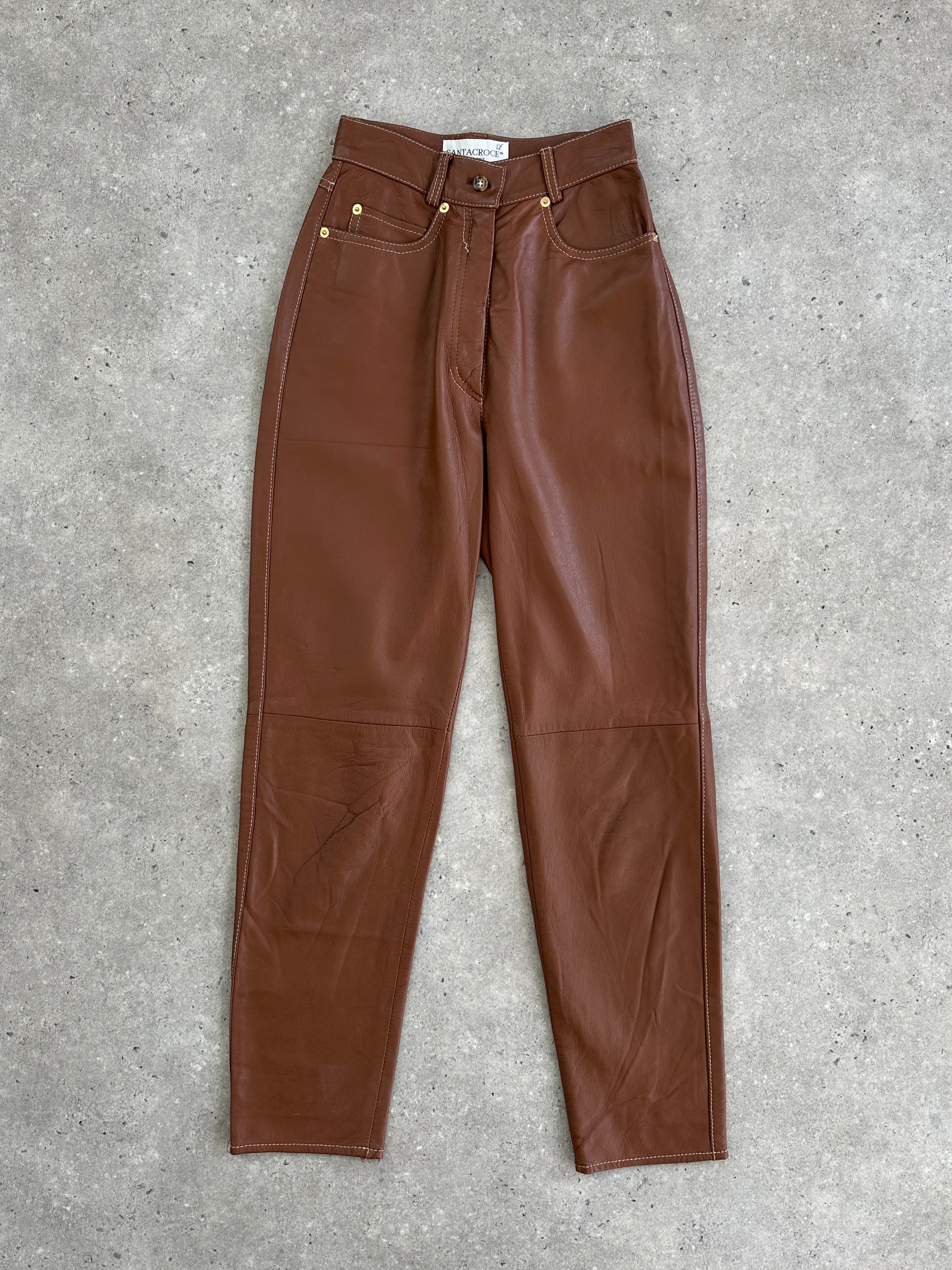 Vintage Italian leather tapered leg high-waisted trousers, showcasing sleek fit and classic vintage style.