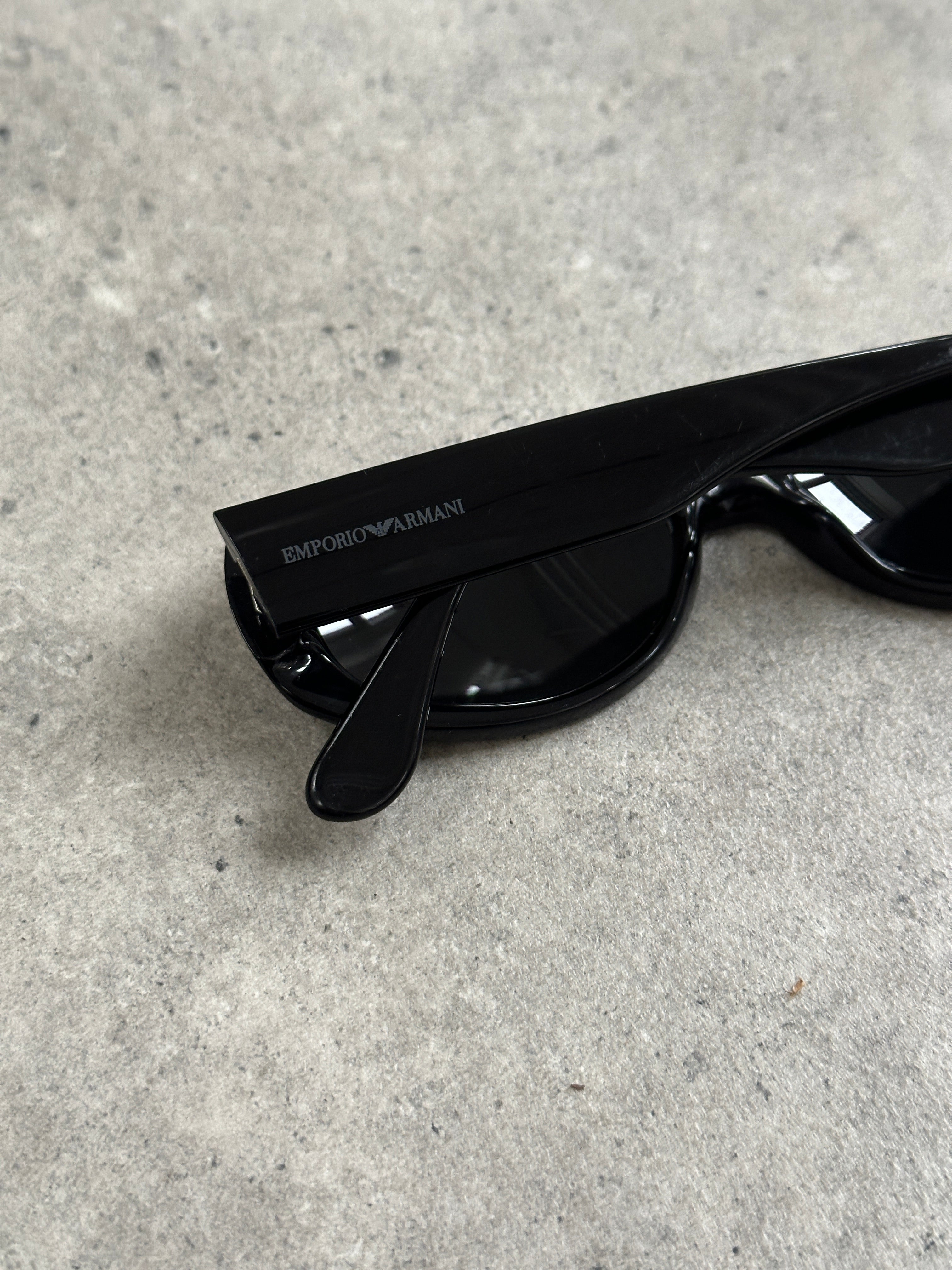 Emporio Armani 2000s oval sunglasses with dark lenses and sleek black frame, stylish eyewear accessory.