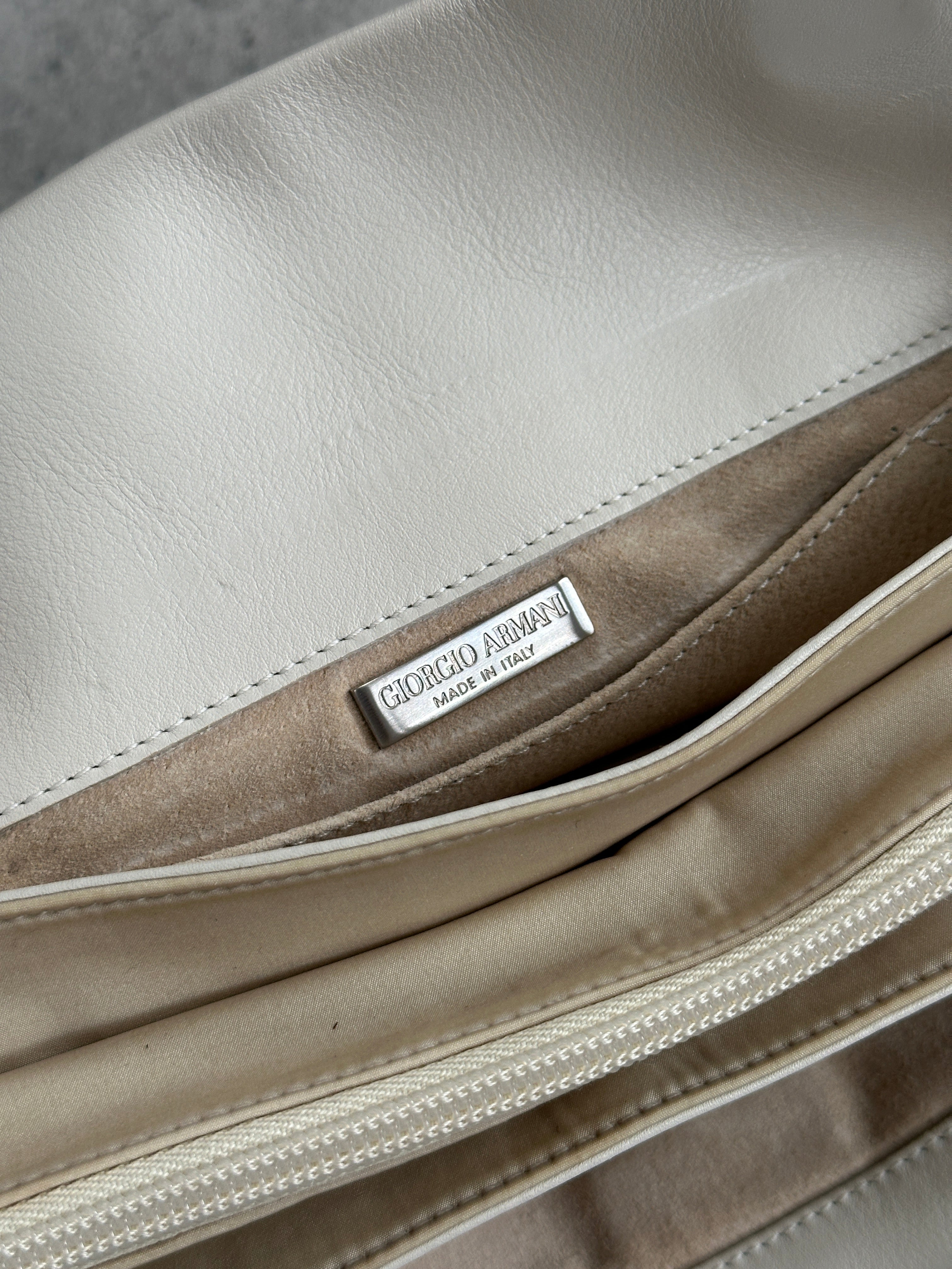 Giorgio Armani Le Collezioni embossed logo handbag with textured leather and sleek design, perfect for stylish accessories.