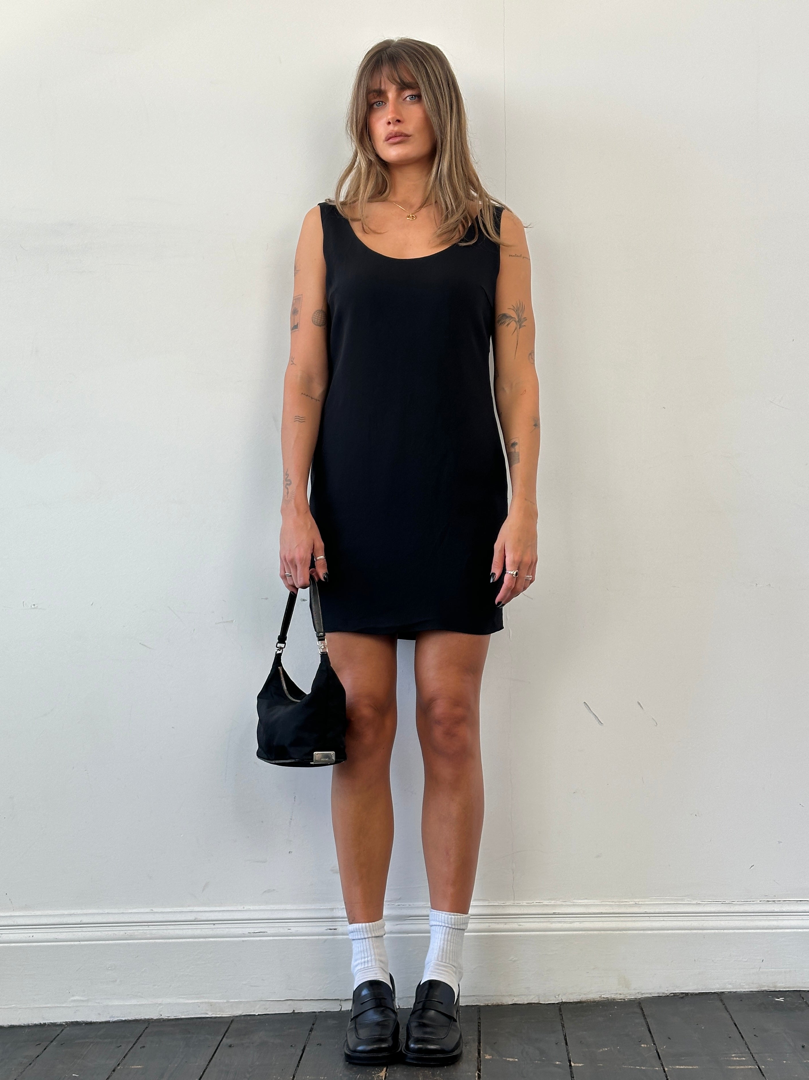 Moschino Couture fitted mini dress in black with bold logo accents, tailored for a chic and modern look.