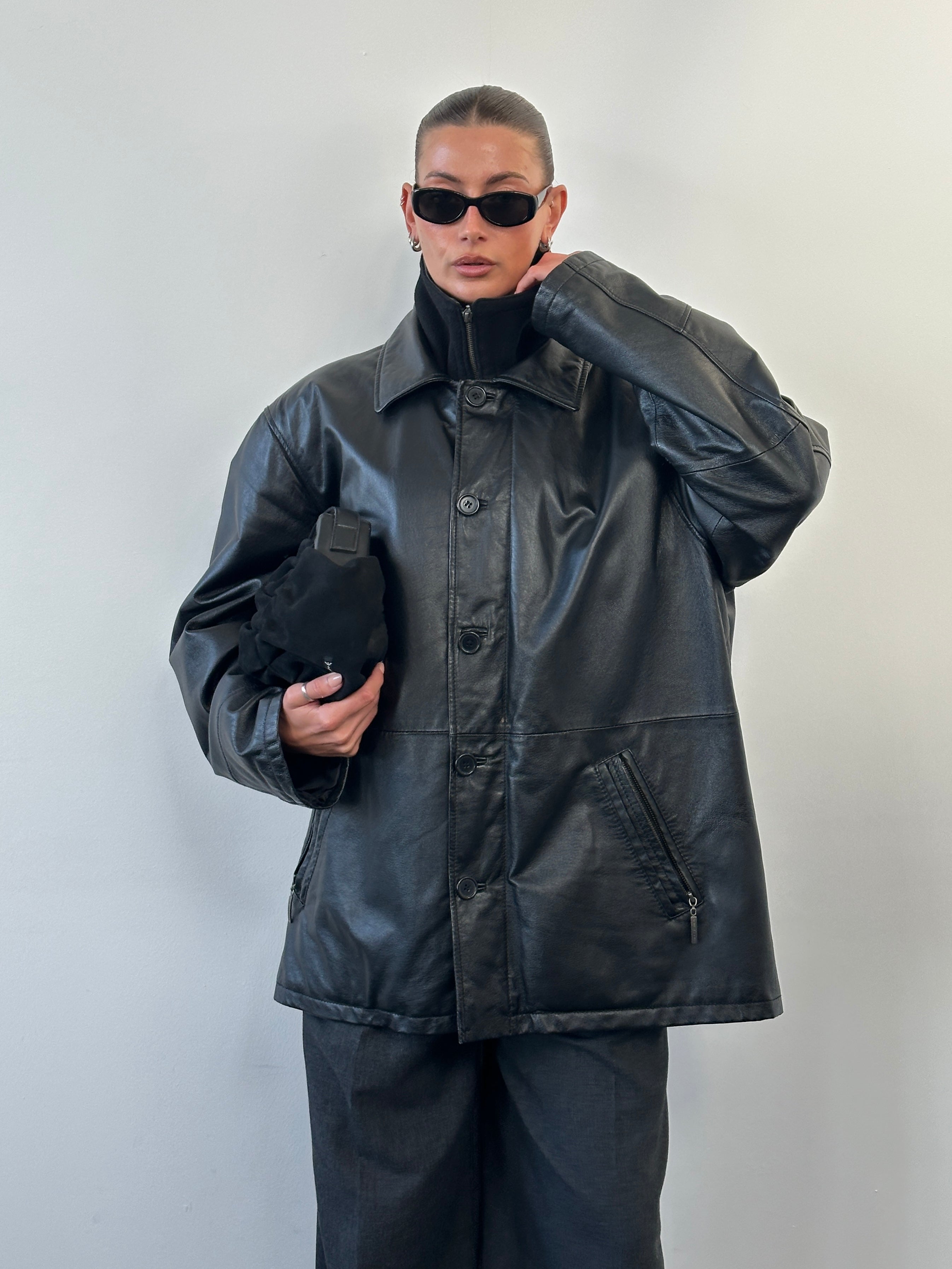 Vintage 1990s XXL leather jacket with funnel neck, brown leather, and classic style, displayed on a hanger.