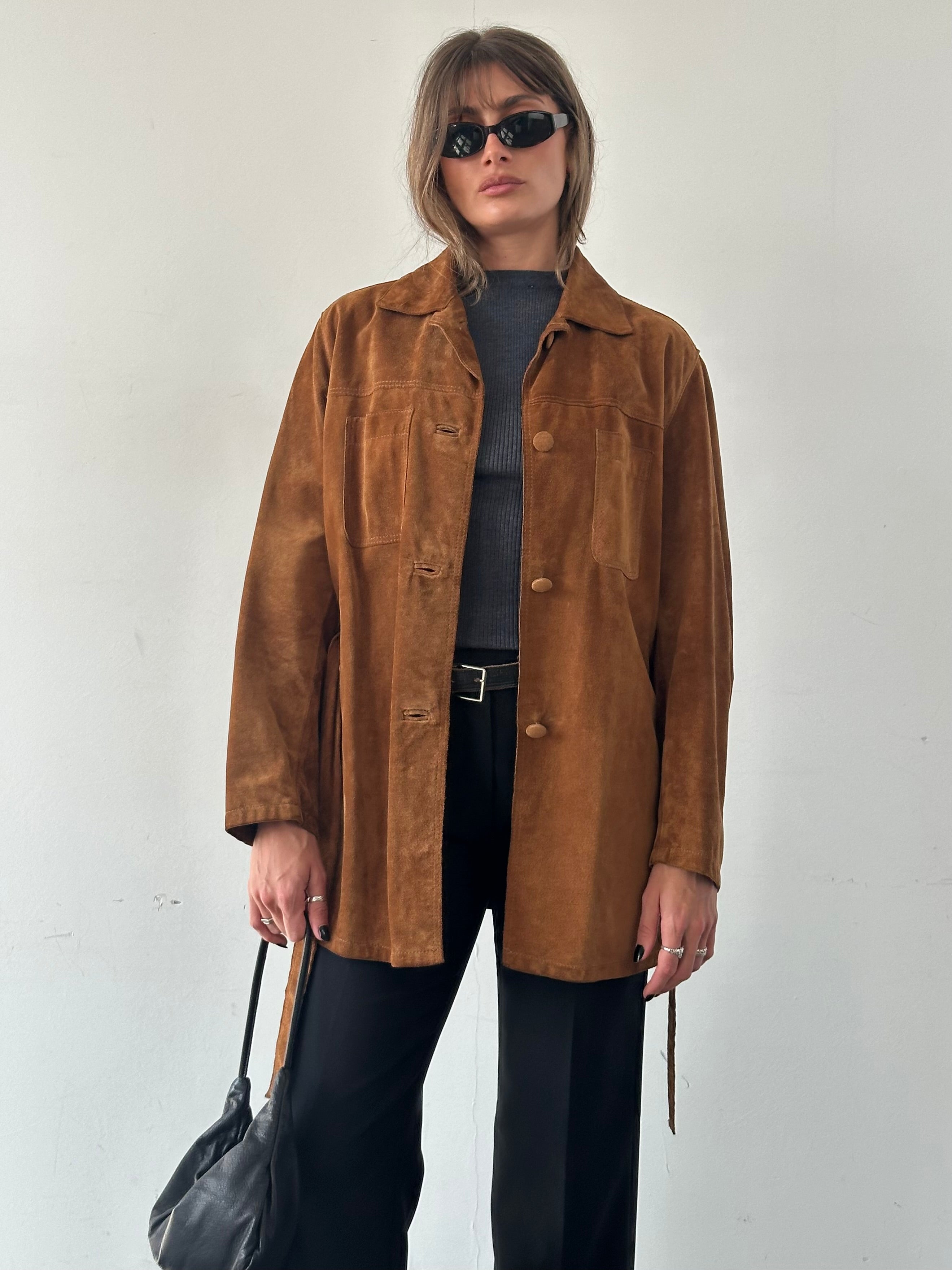 Vintage Italian belted suede jacket in size M/L, featuring a classic design and rich suede texture, displayed on a hanger.