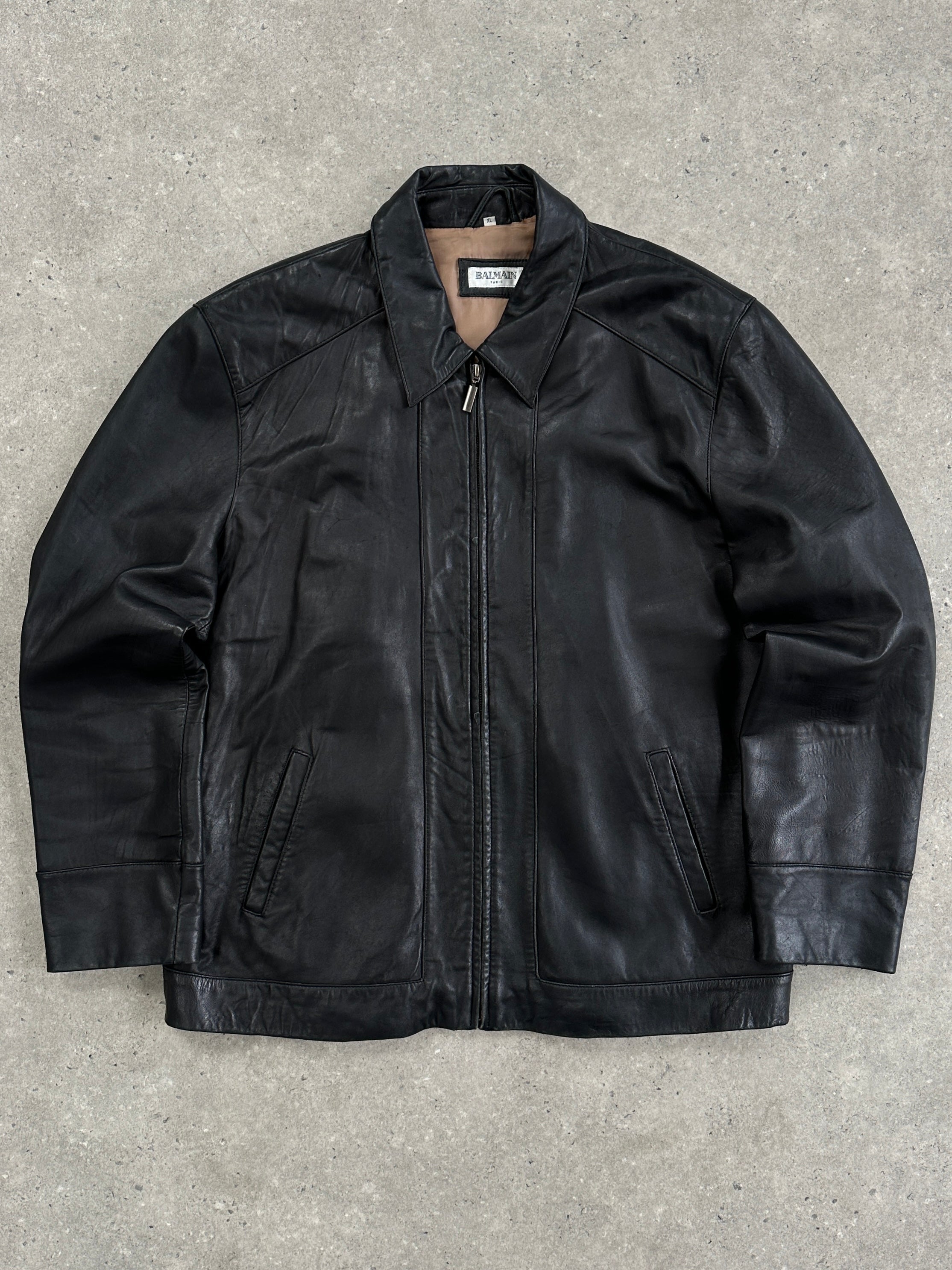Balmain smooth leather jacket in size XL, featuring sleek design and classic collar, displayed on a neutral background.