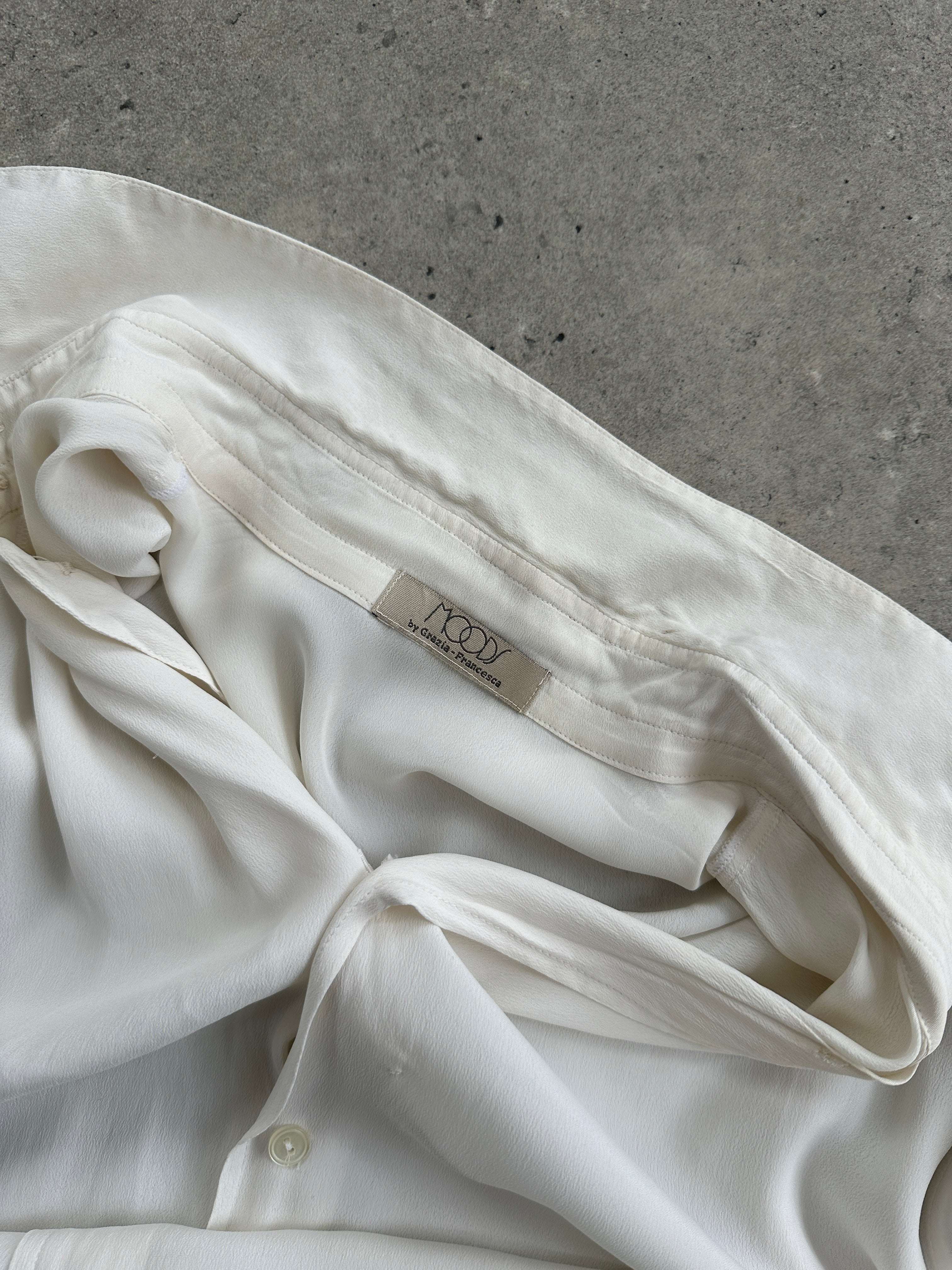 Vintage silk flowy shirt in size L, showcasing a lightweight, elegant design with a relaxed fit and smooth fabric.