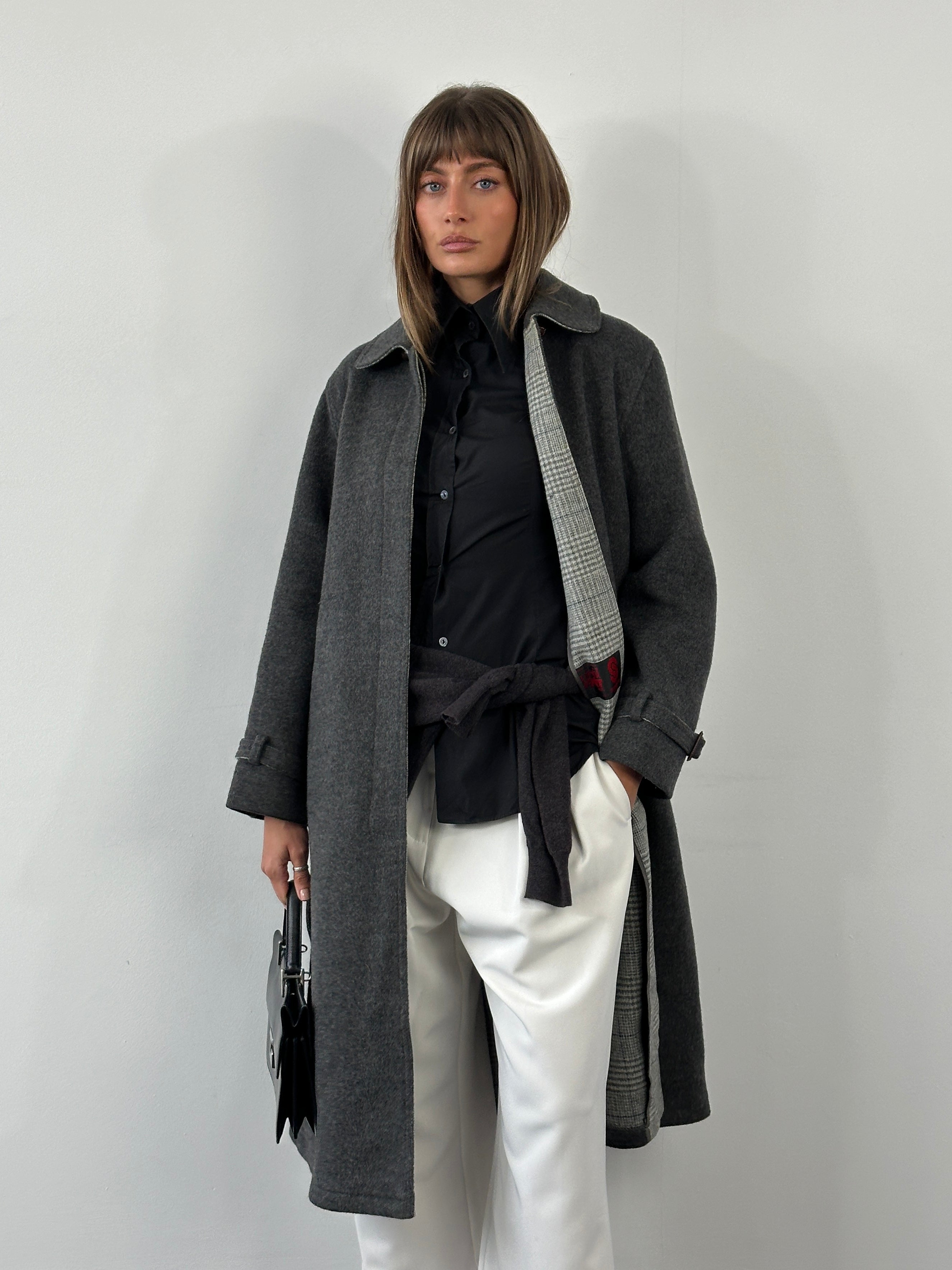 Vintage 1980s wool coat with belted waist and concealed placket, shown in classic style with a structured silhouette.