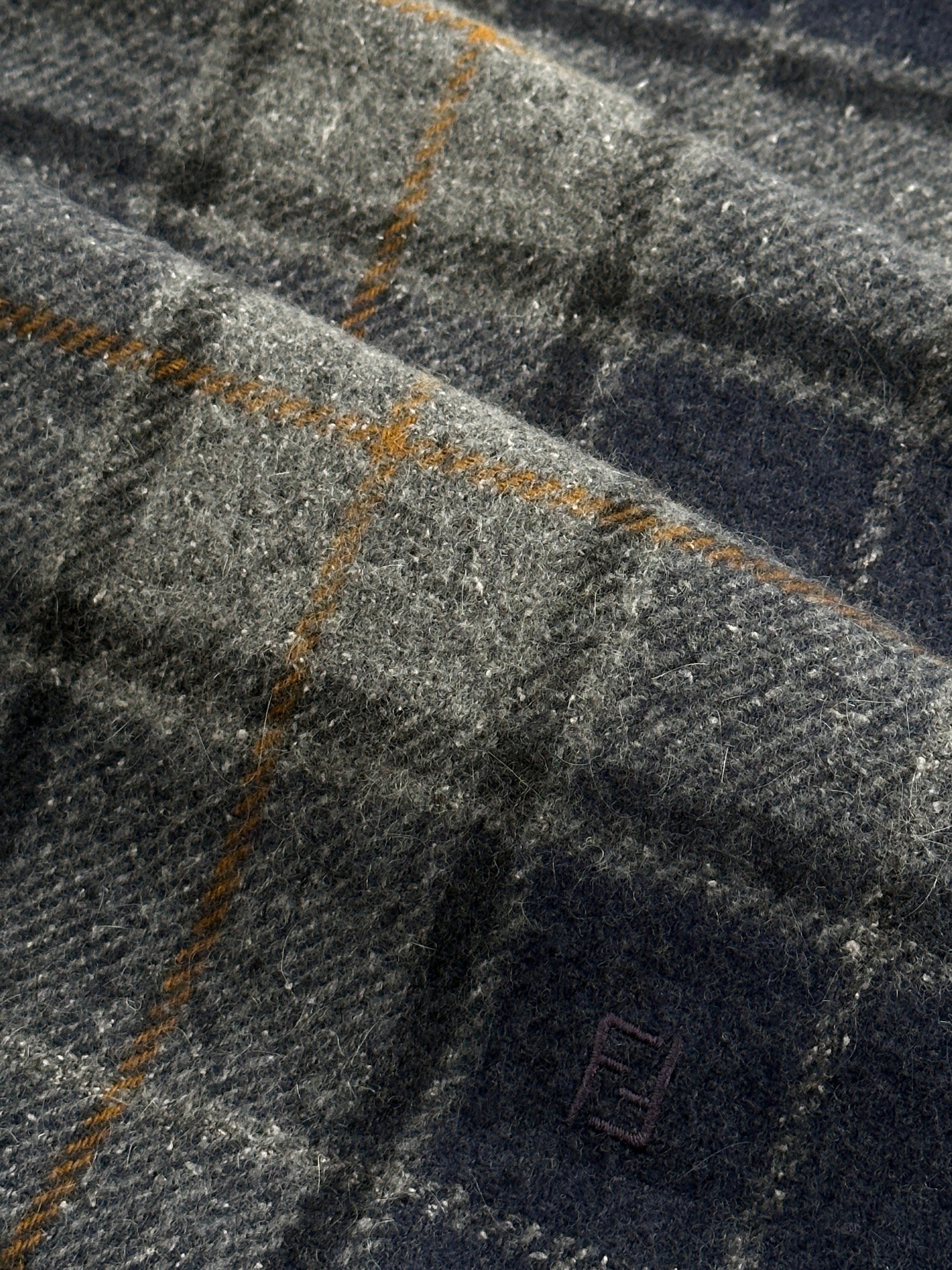 Fendi Pure Wool Logo Check Scarf with classic pattern, soft texture, and fringed edges, showcasing the luxurious designer accessory.