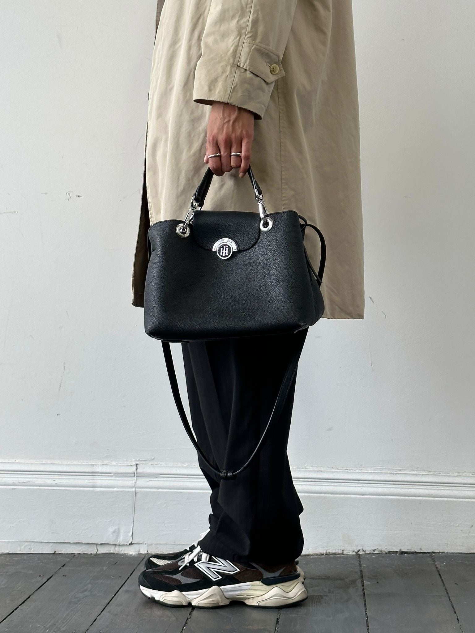 Tommy Hilfiger crossbody bag with adjustable strap, featuring signature logo and classic design, shown on a plain background.