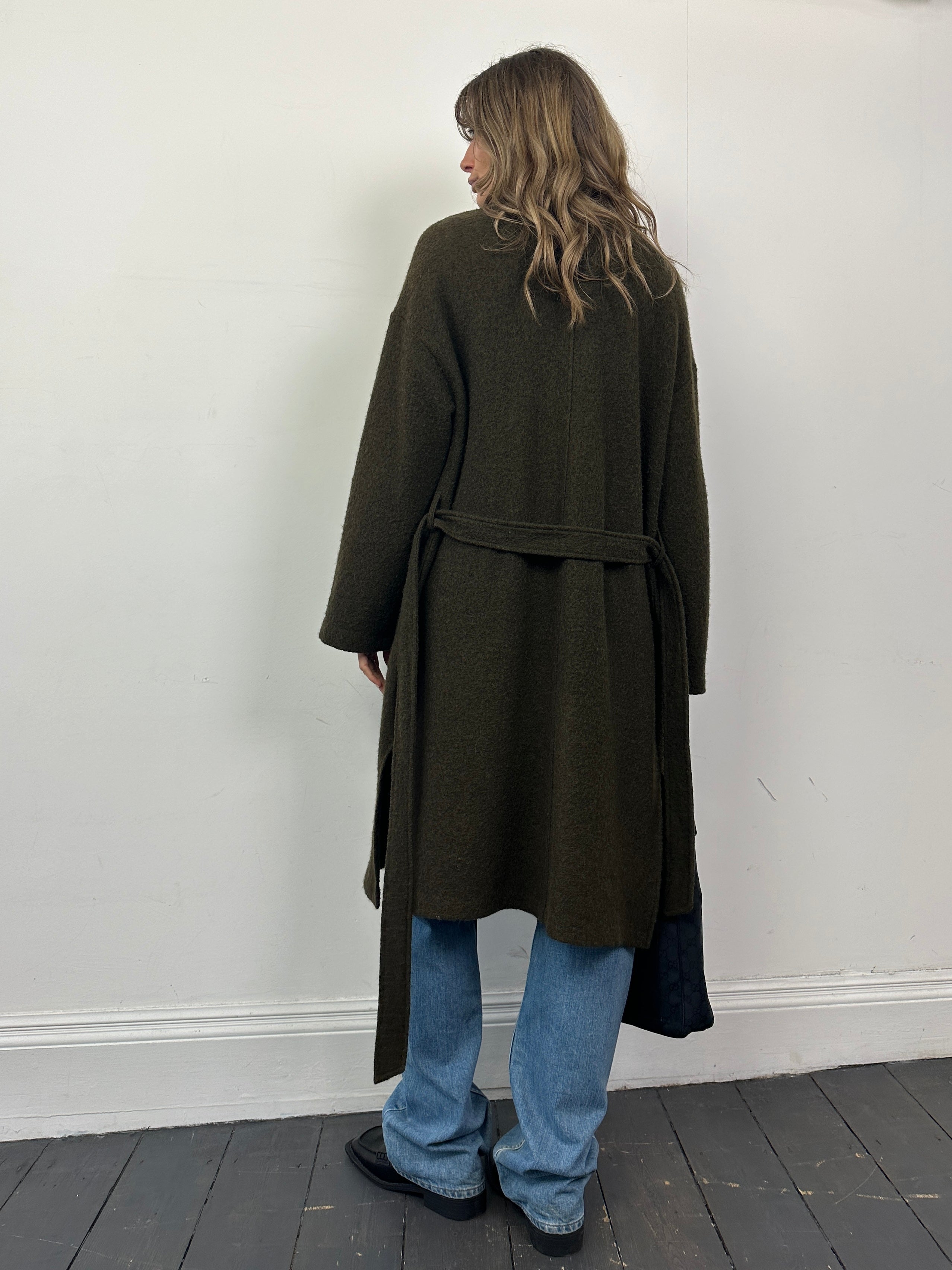 Nicole Farhi pure wool unlined belted wrap coat in size L, shown on a hanger with a neutral background.