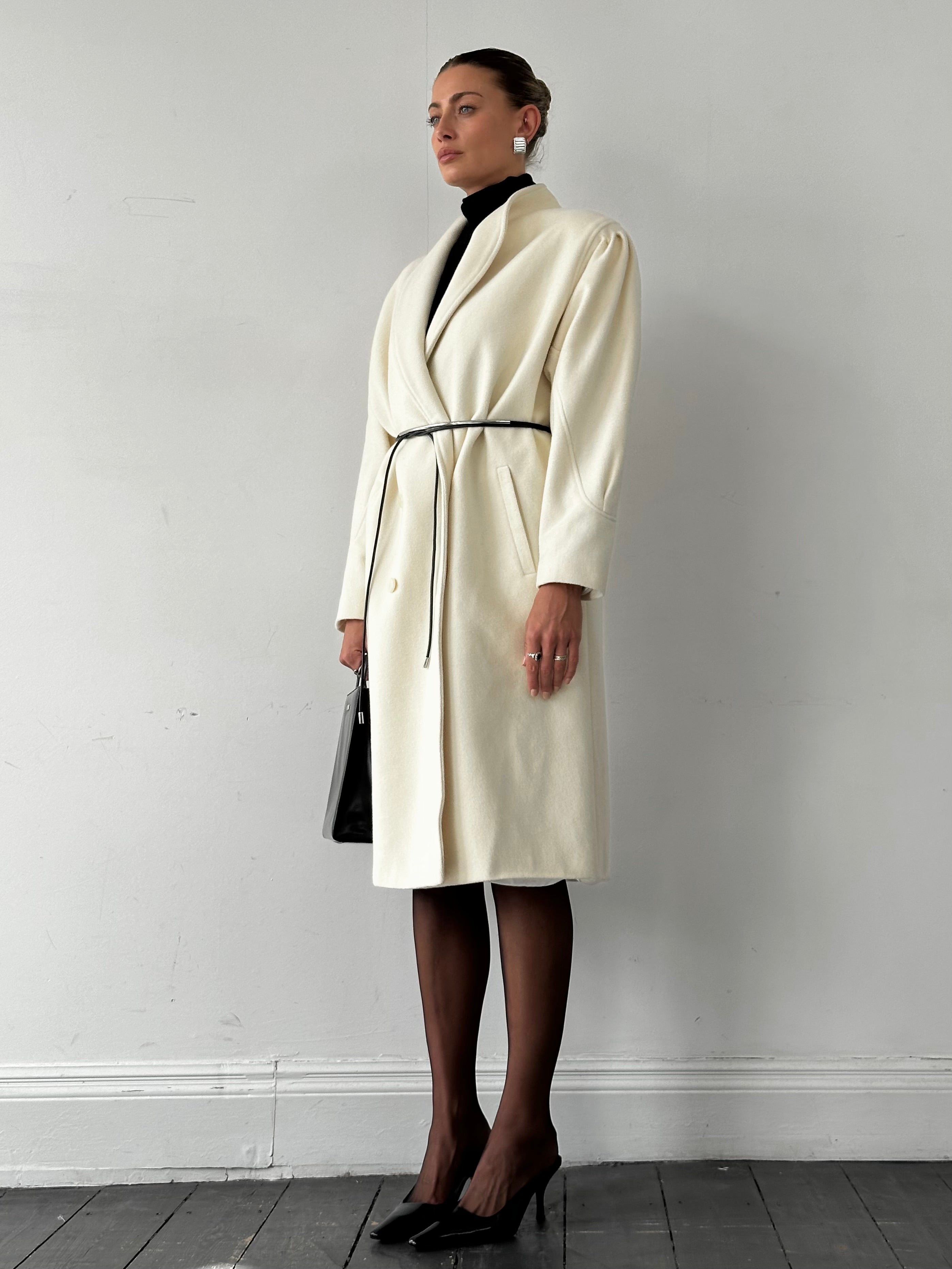 Vintage pure wool double-breasted coat in size L/XL, featuring classic style and tailored fit, shown on a hanger.