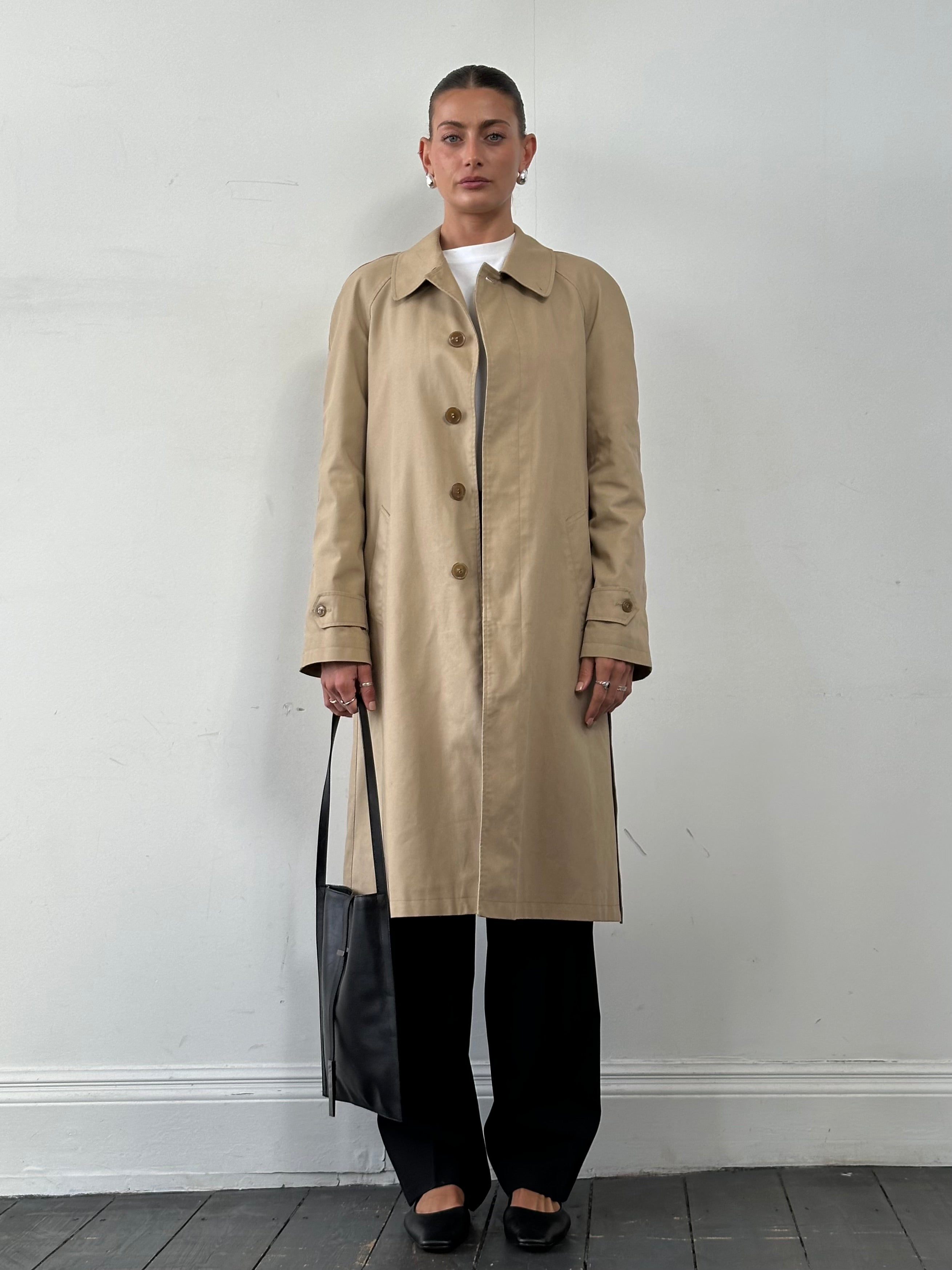 Vintage cotton belted trench coat in XL size, classic design with button details and a waist belt, stylish outerwear for women.