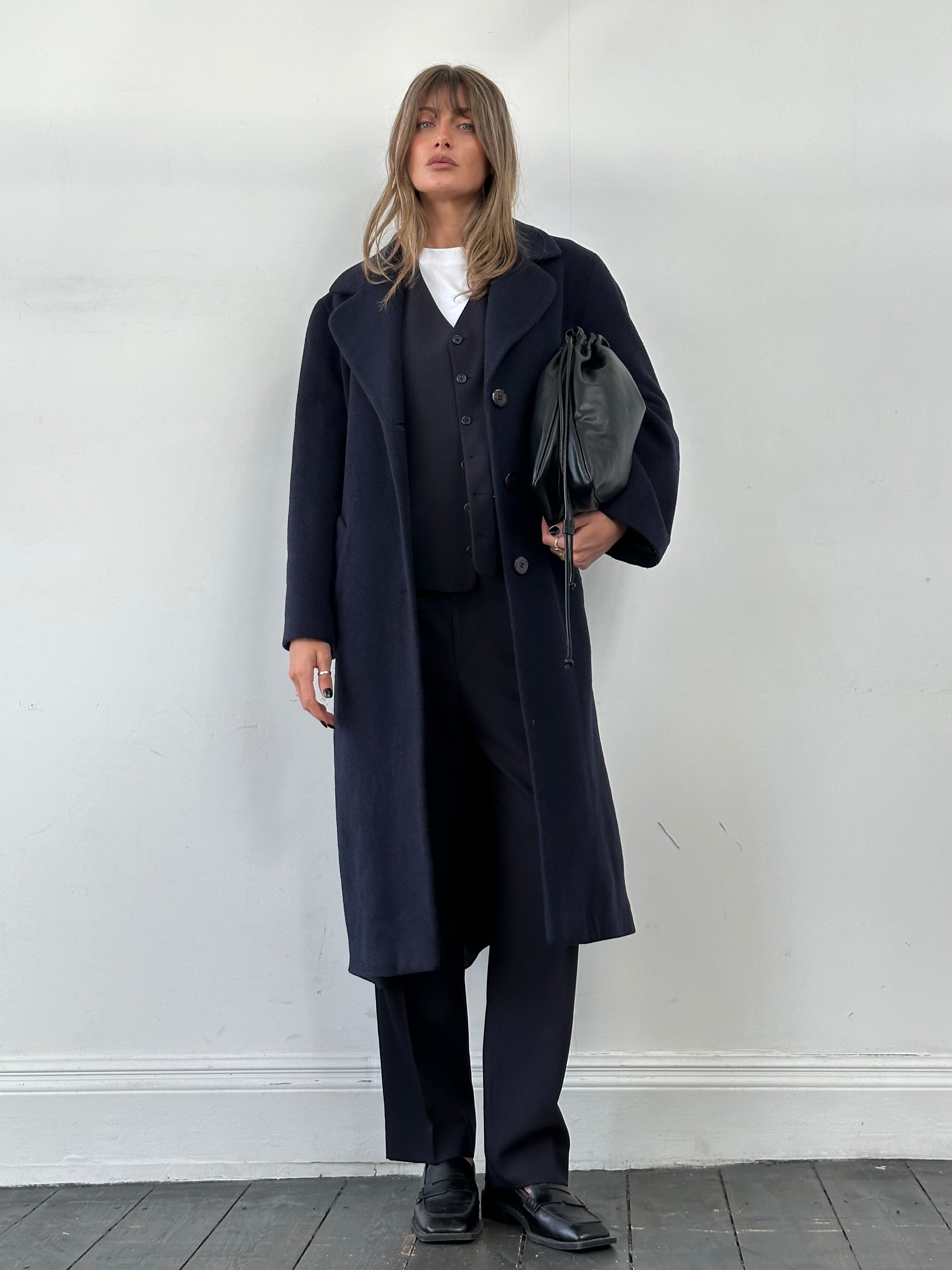 Vintage Virgin Wool single-breasted coat in size M, shown on a hanger, featuring classic design and textured wool fabric.