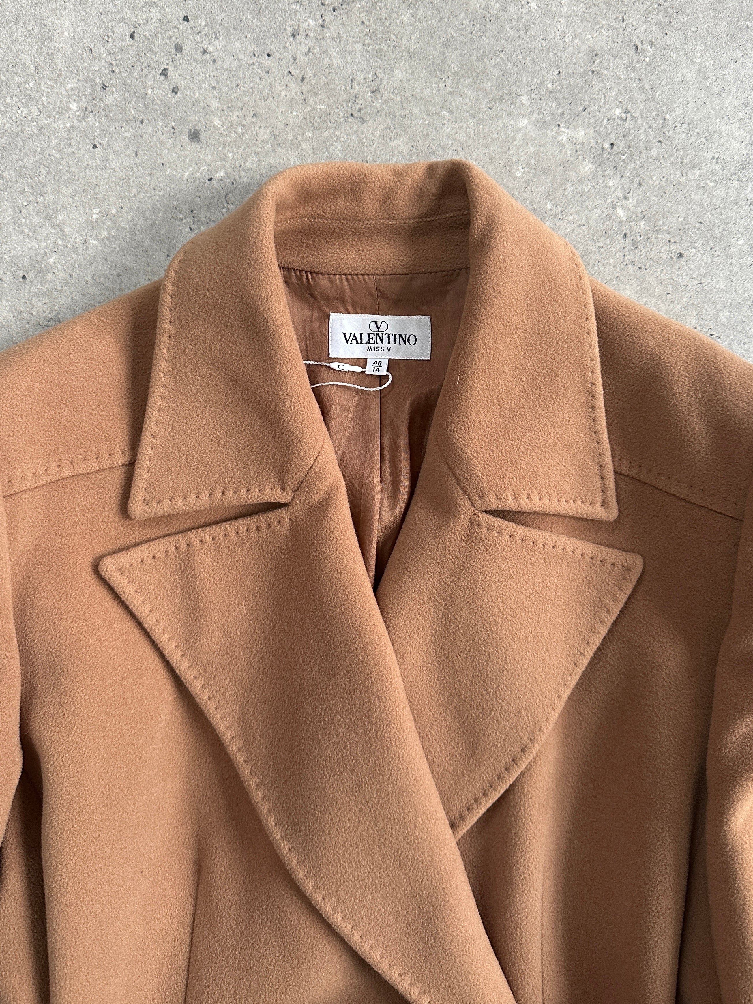 Valentino 1990s pure wool double-breasted bespoke belted coat in size L, displayed on a hanger with classic tailored details.
