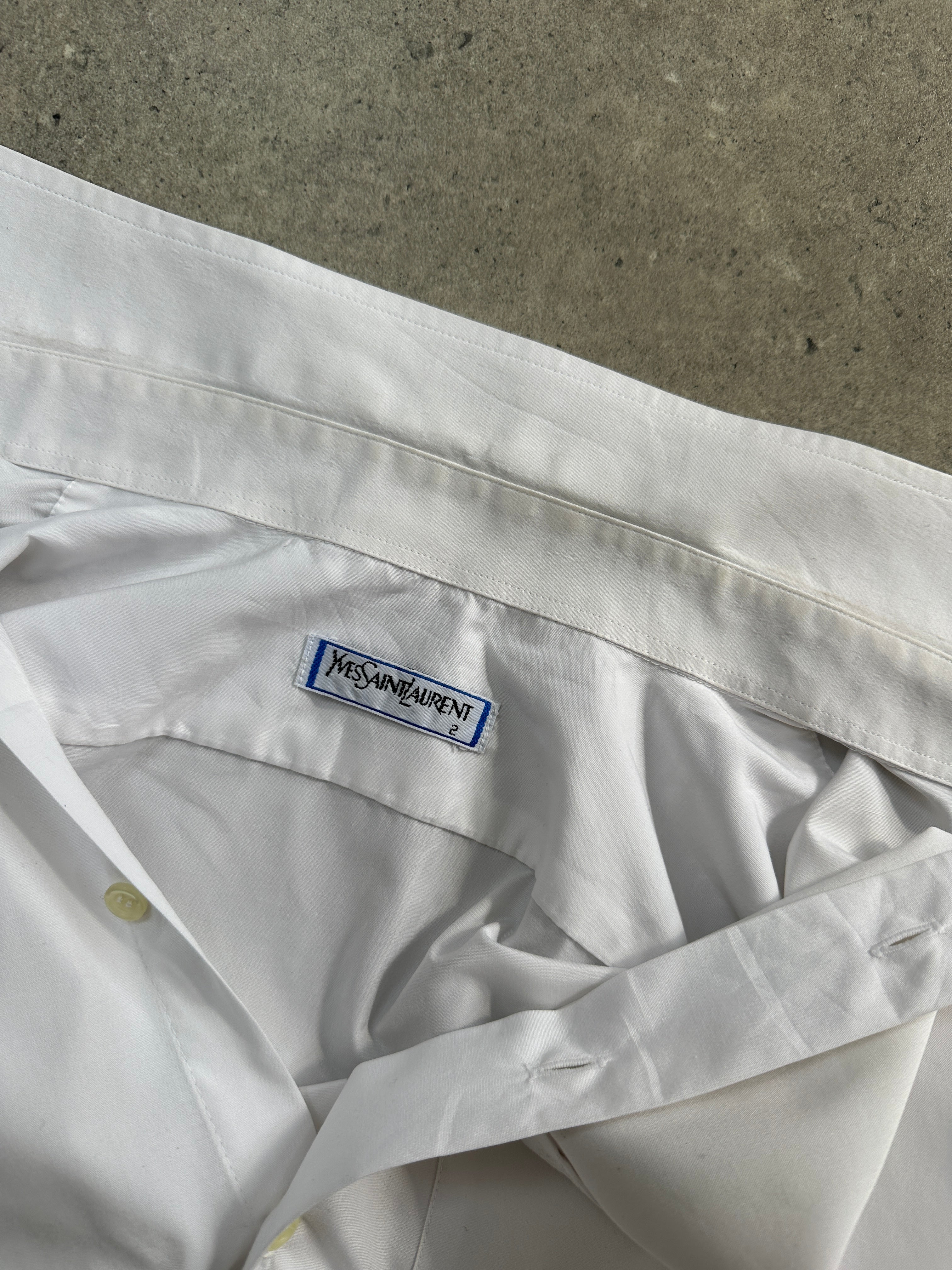 Yves Saint Laurent 1980s logo cotton short sleeve shirt in black with white branding, size S/M, laid flat.