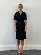 Vintage 1990s belted short sleeve midi shirt dress shown in natural fabric with a classic collar and waist tie, size large.