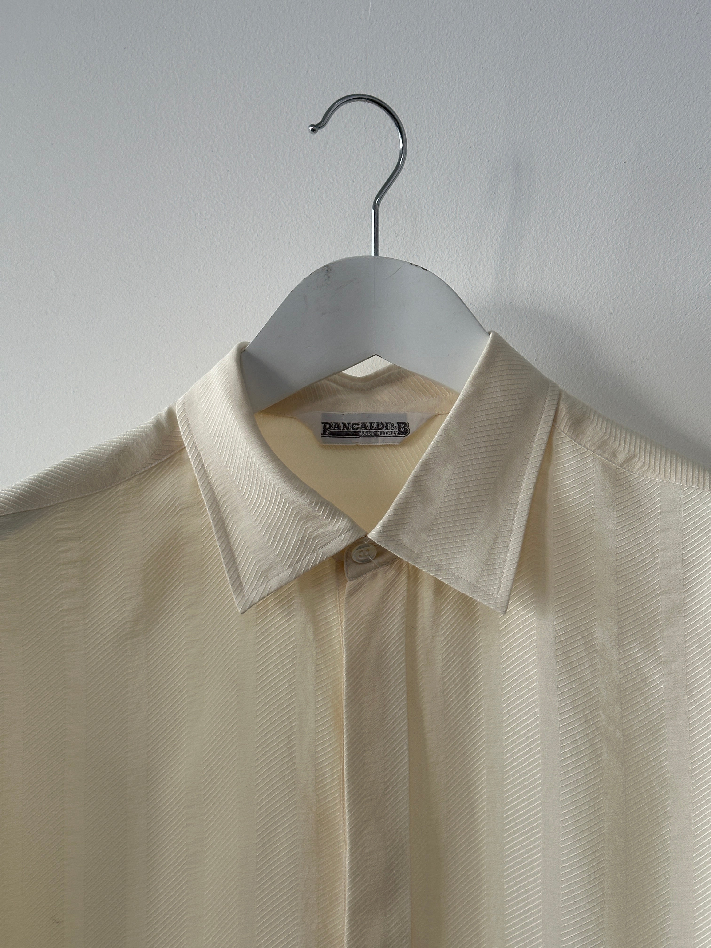Vintage pure silk polo shirt in size L/XL, showcasing a classic design with a smooth silk texture and collar detail.
