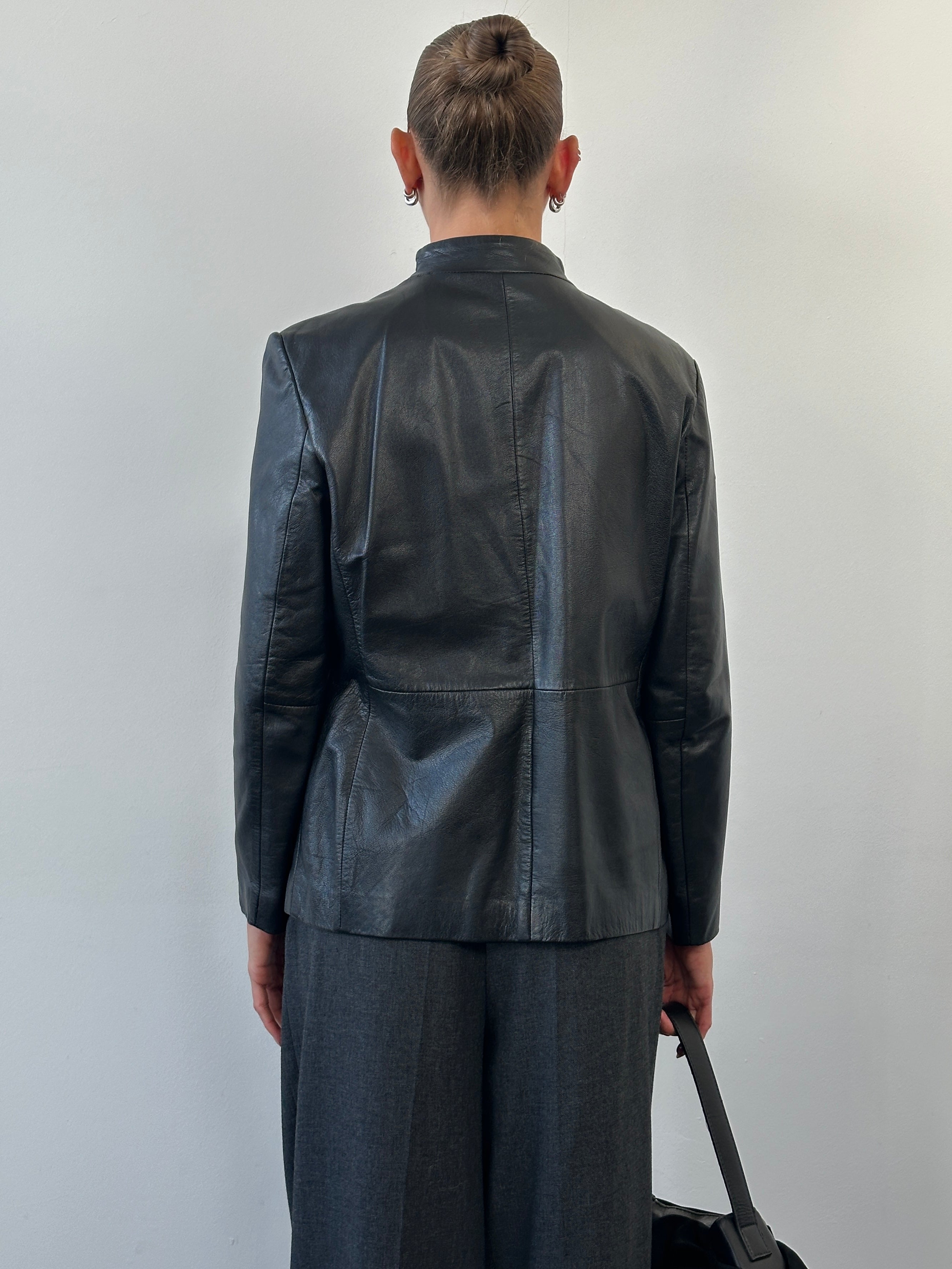Vintage 1990s minimal round neck leather jacket in size M, classic black leather with clean design and smooth texture.